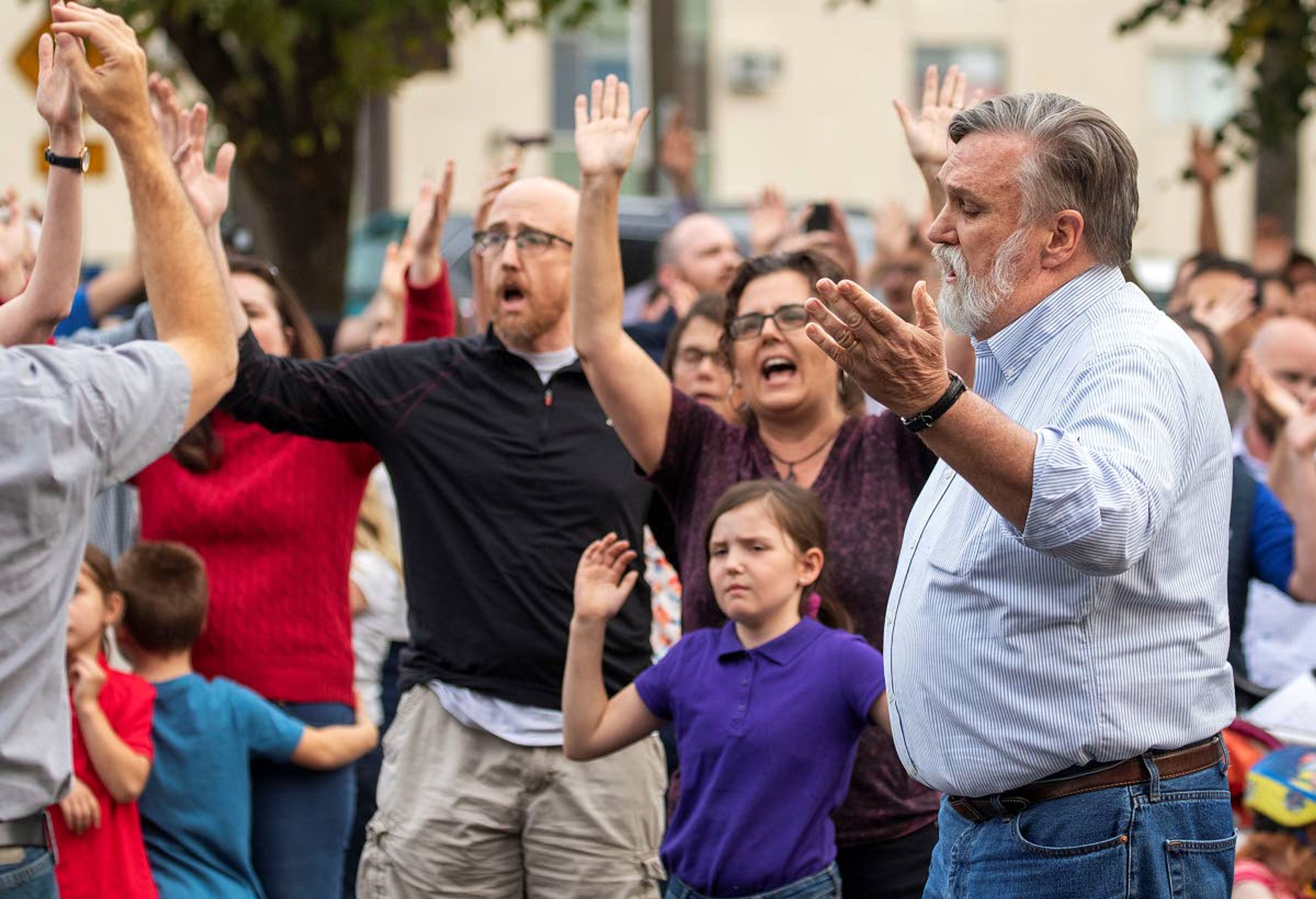 Christ Church Pastor Doug Wilson, right, sings "The Doxology" with church members during a "flash psalm sing" organized by the church on Wednesday outside Moscow City Hall.