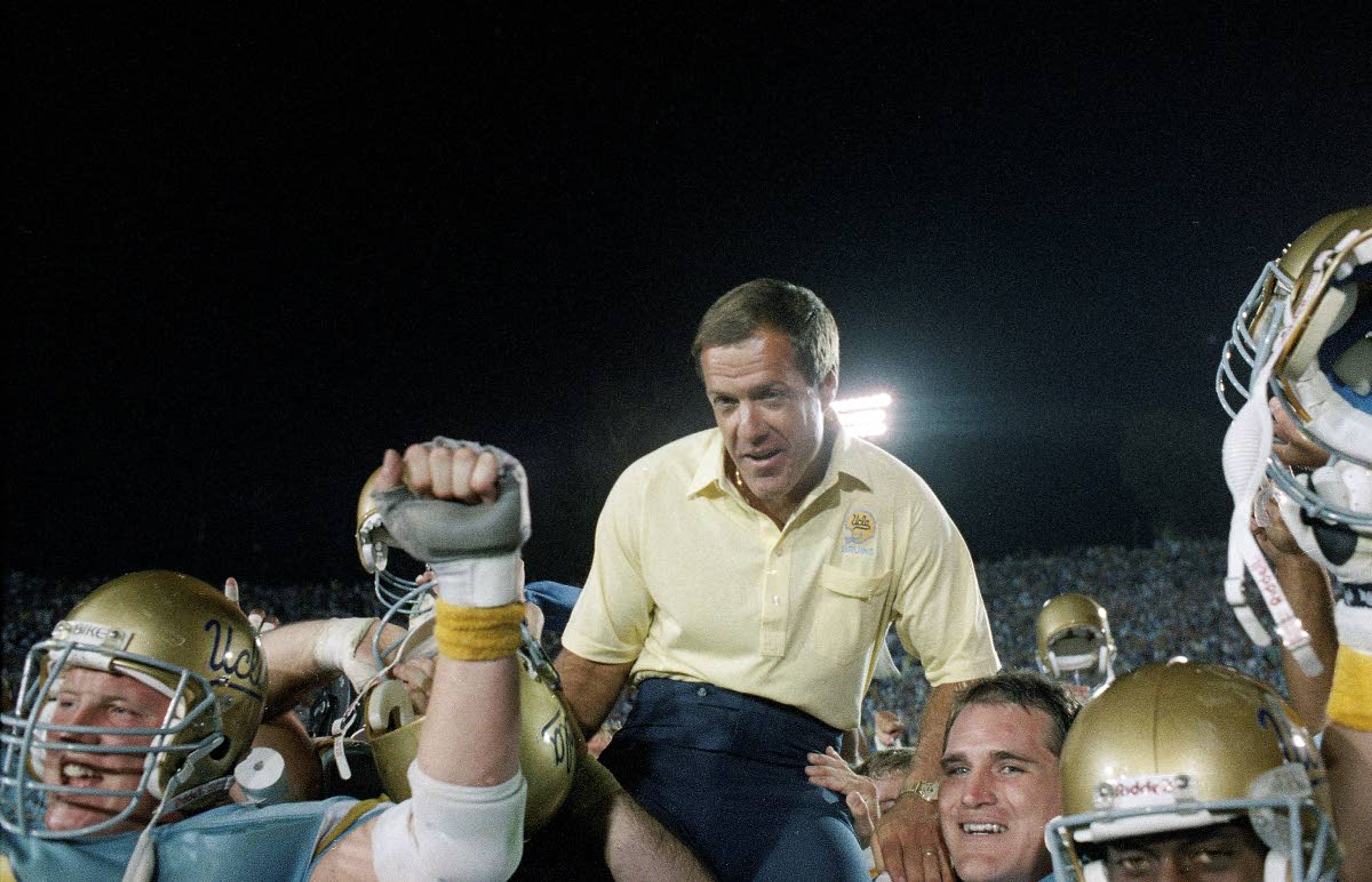 FILE - In this Sept. 10, 1988, file photo, UCLA coach Terry Donahue is carried off the field by his players after UCLA defeated Nebraska, 41-28 at the Rose Bowl in Pasadena, Calif. The victory was Donahue's 100th as Bruin coach. Donahue, the winningest coach in Pac-12 Conference and UCLA football history who later served as general manager of the NFL’s San Francisco 49ers, died Sunday, July 4, 2021. He was 77. (AP Photo/Reed Saxon, File)