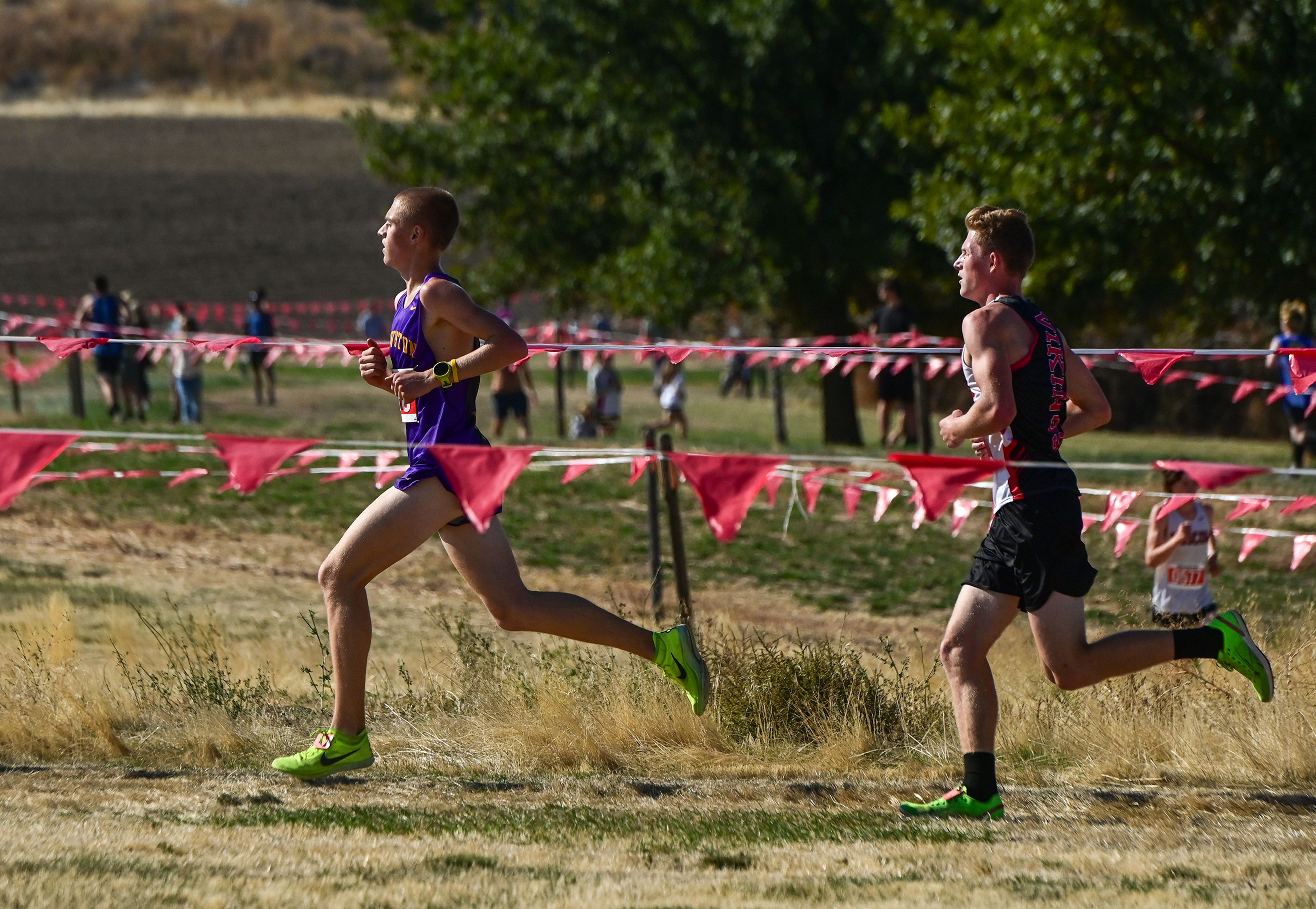 Lewiston's Lucas Clements, left, and Garfield-Palouse's Kieran Snekvik, right, compete in the Inland Empire Championships varsity boys 5K Saturday along the LCSC XC Course in Lewiston.,