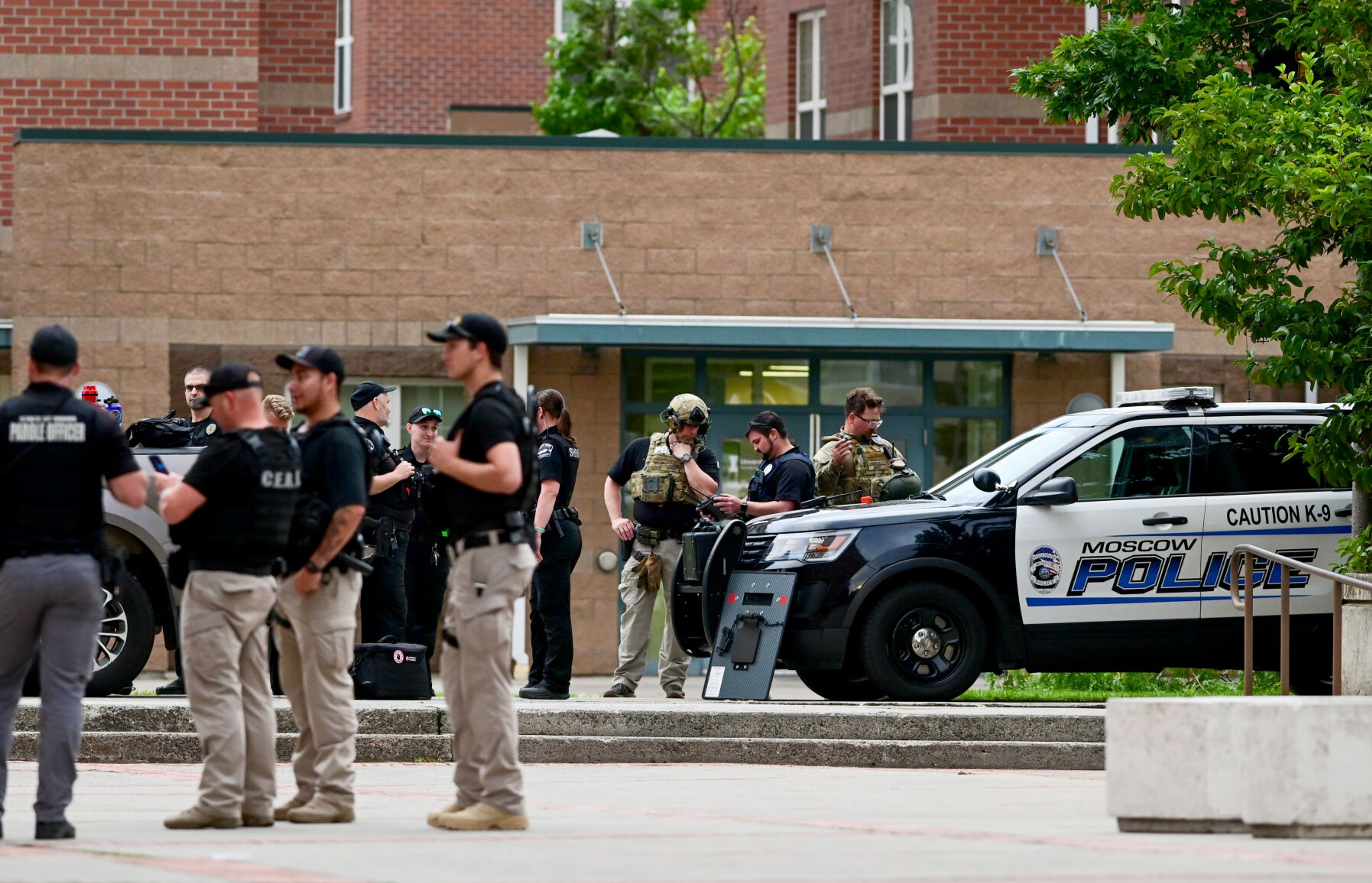 Police move to the front of Theophilus Tower after searching the dormitory on the University of Idaho campus on Tuesday in Moscow. Officers responded to reports that an inmate walked away from a cleaning crew that afternoon.