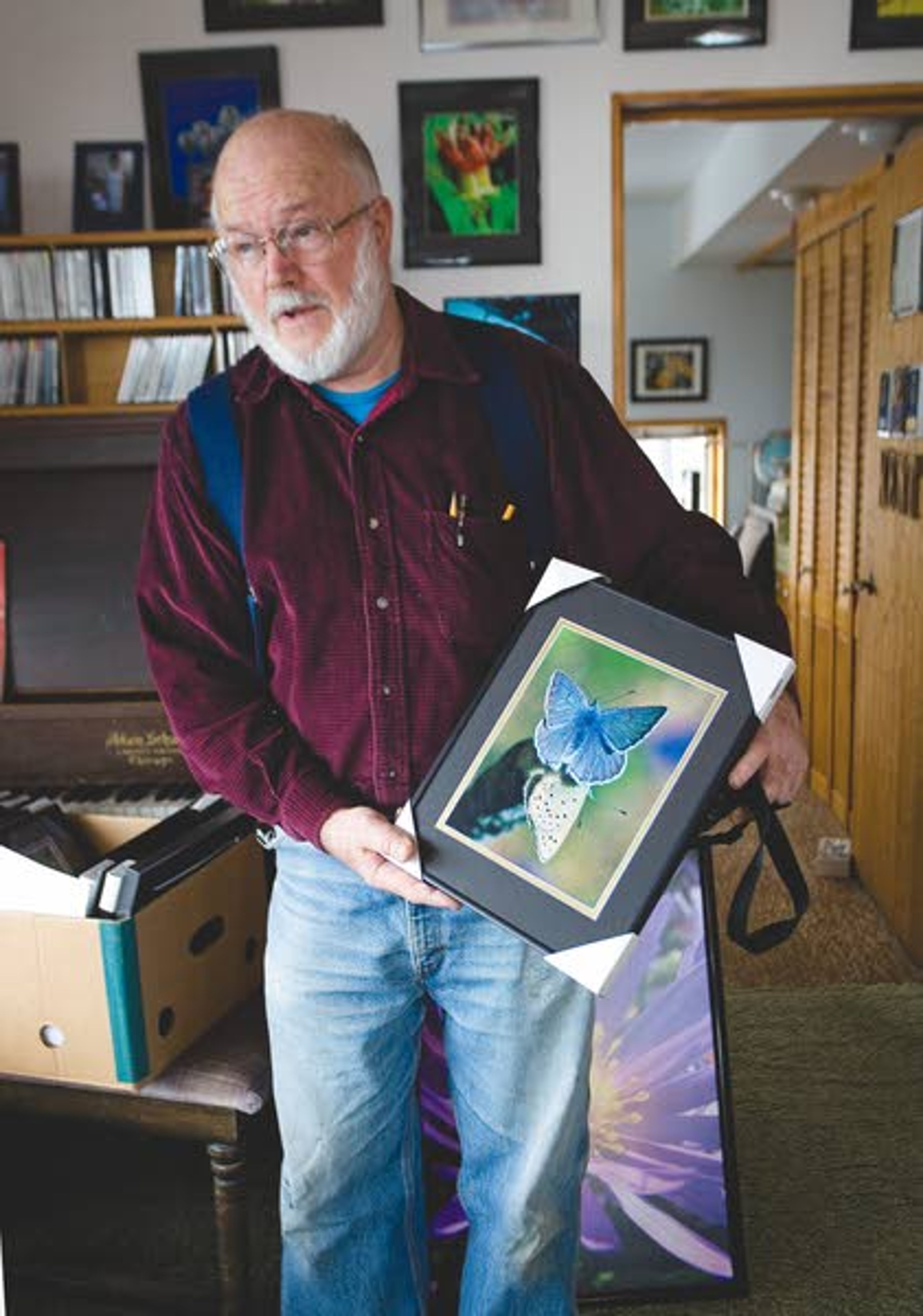 Gerry Queener talks Friday at his home in Troy about a photograph of a butterfly taken near Hells Canyon.