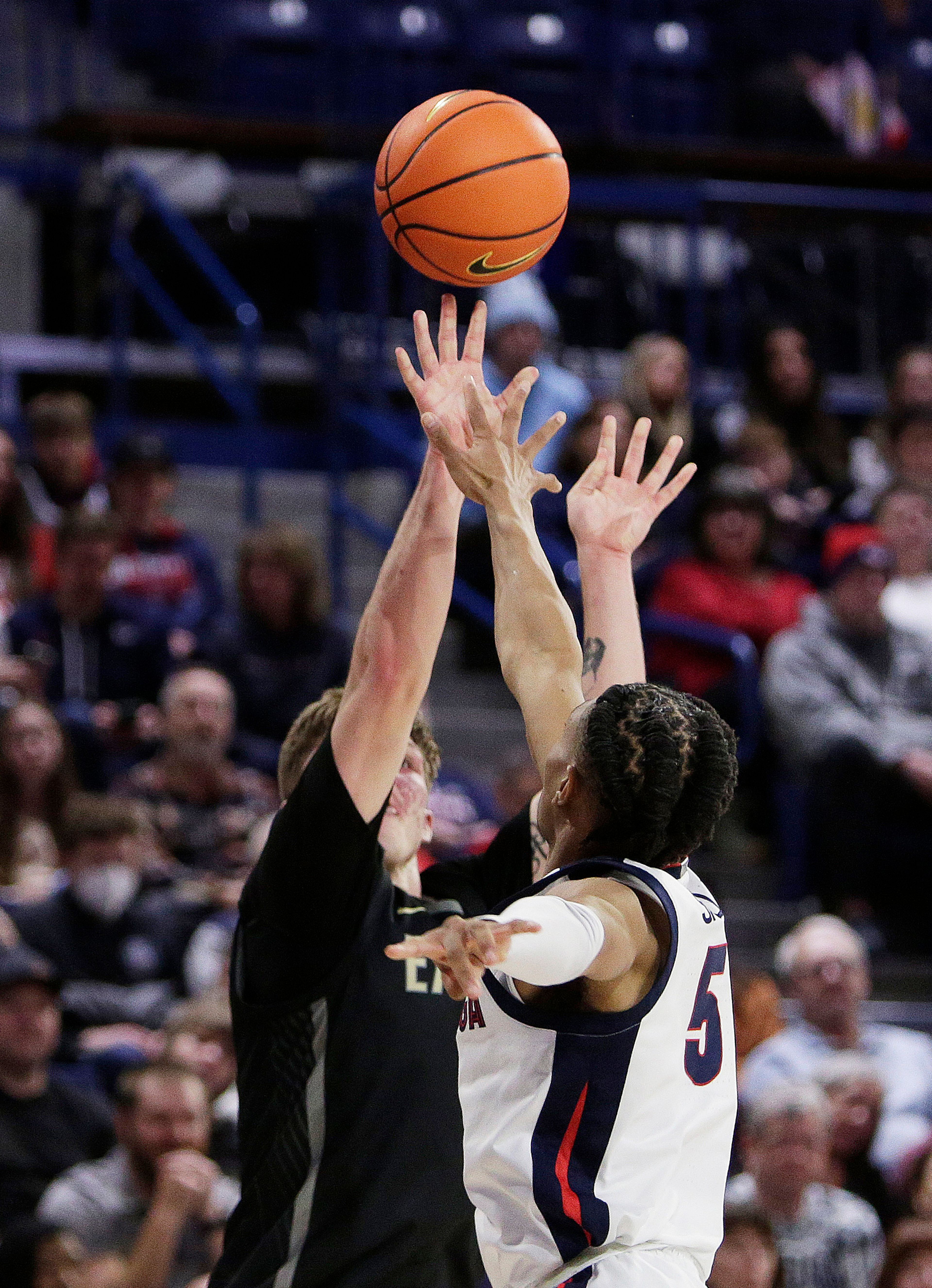 Eastern Oregon guard Preston Chandler, left, shoots while defended by Gonzaga guard Hunter Sallis during the first half of a college basketball game, Wednesday, Dec. 28, 2022, in Spokane, Wash. (AP Photo/Young Kwak)