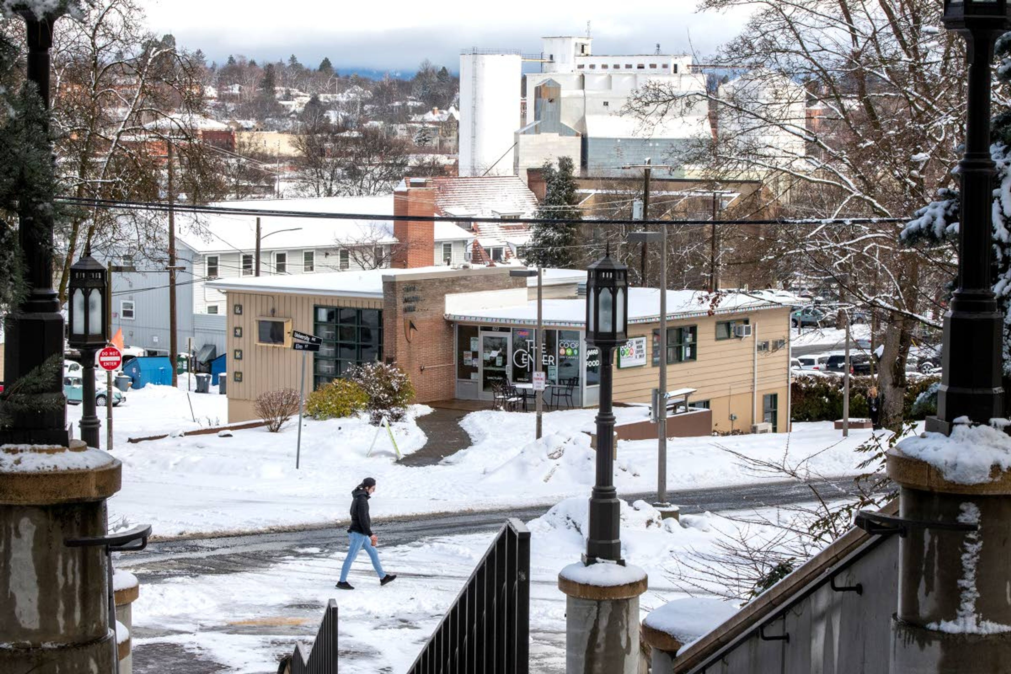 Zach Wilkinson/Daily NewsA woman walks past the steps of the Hello Walk on the University of Idaho’s campus Feb. 26. The grain silos, top center, border the planned downtown end of a proposed pathway to connect the university and downtown Moscow.