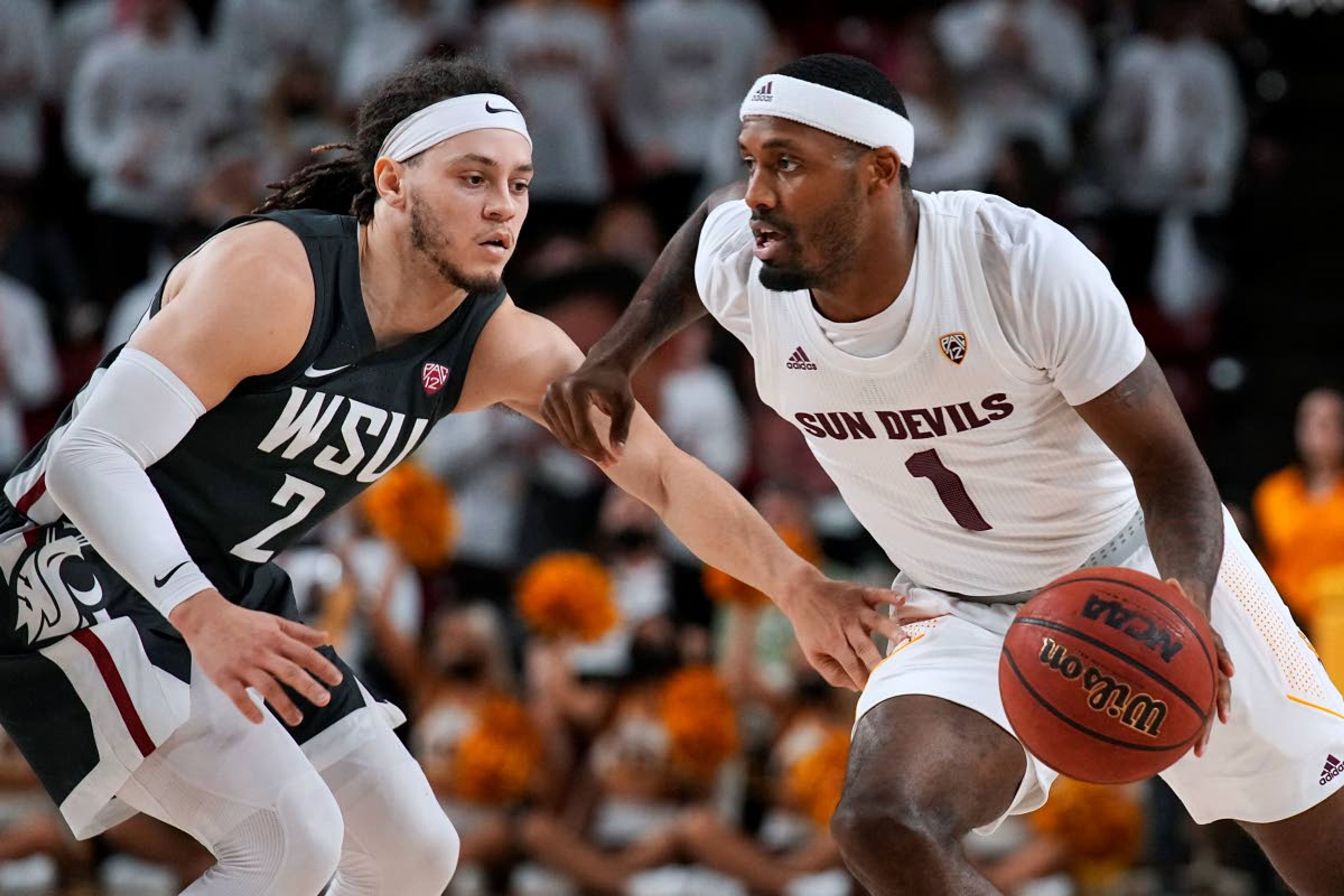 Arizona State guard Luther Muhammad (1) drives on Washington State guard Tyrell Roberts during the second half of an NCAA college basketball game Wednesday, Dec. 1, 2021, in Tempe, Ariz. Washington State won 51-29. (AP Photo/Rick Scuteri)