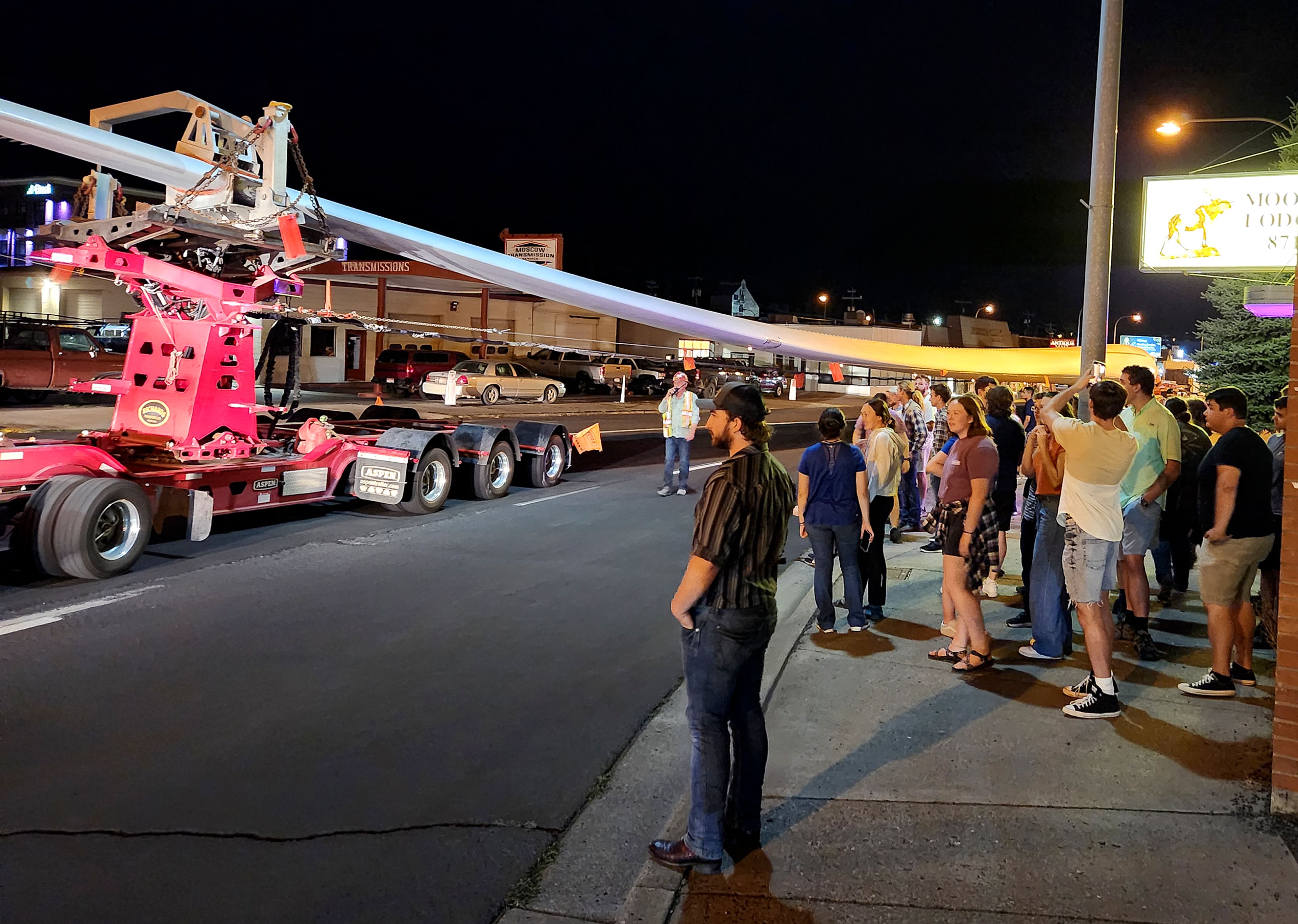 People watch Wednesday night as a wind turbine blade is transported through Moscow.