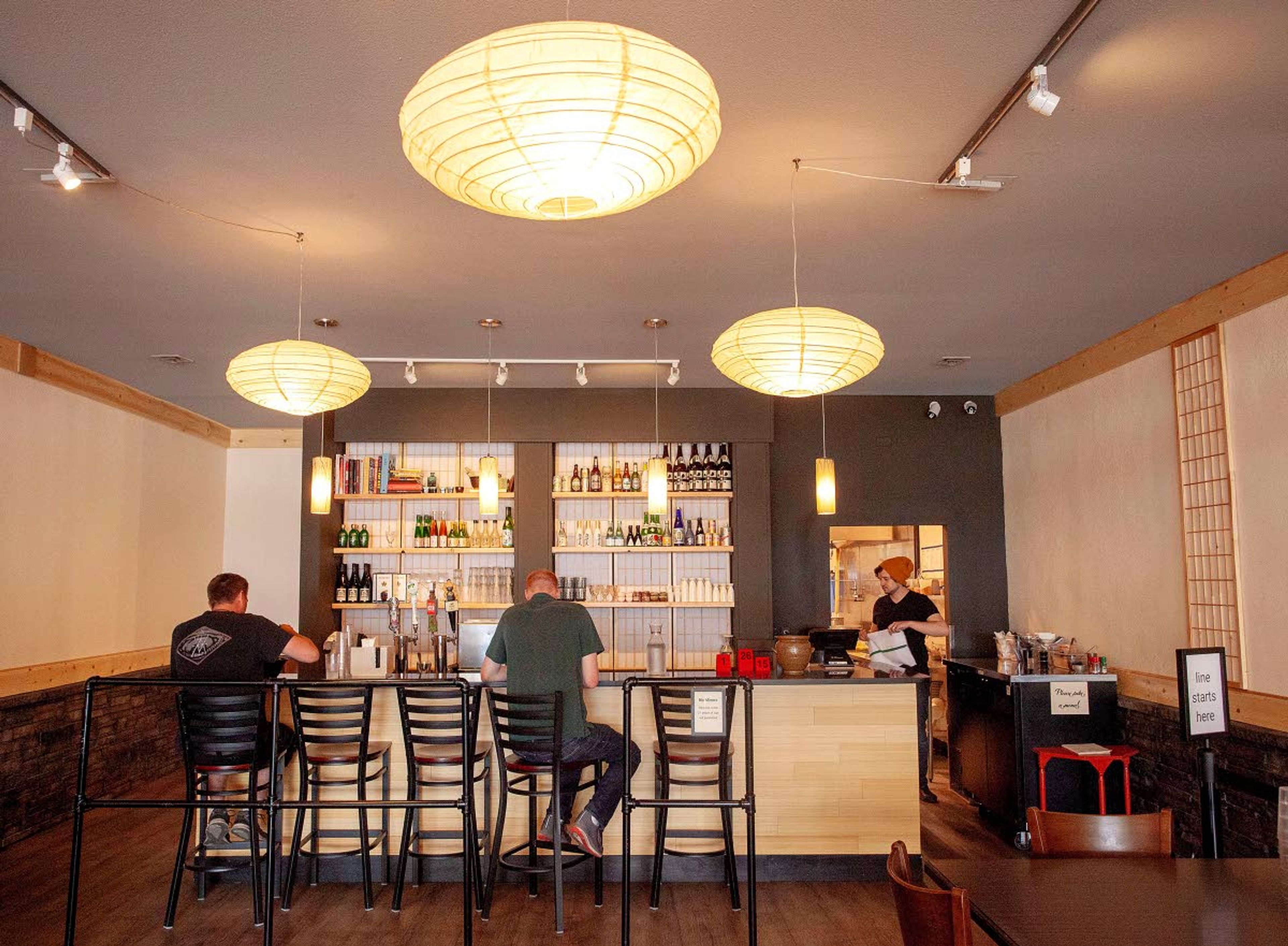 Diners sit at the counter at O-Ramen in downtown Pullman in March.