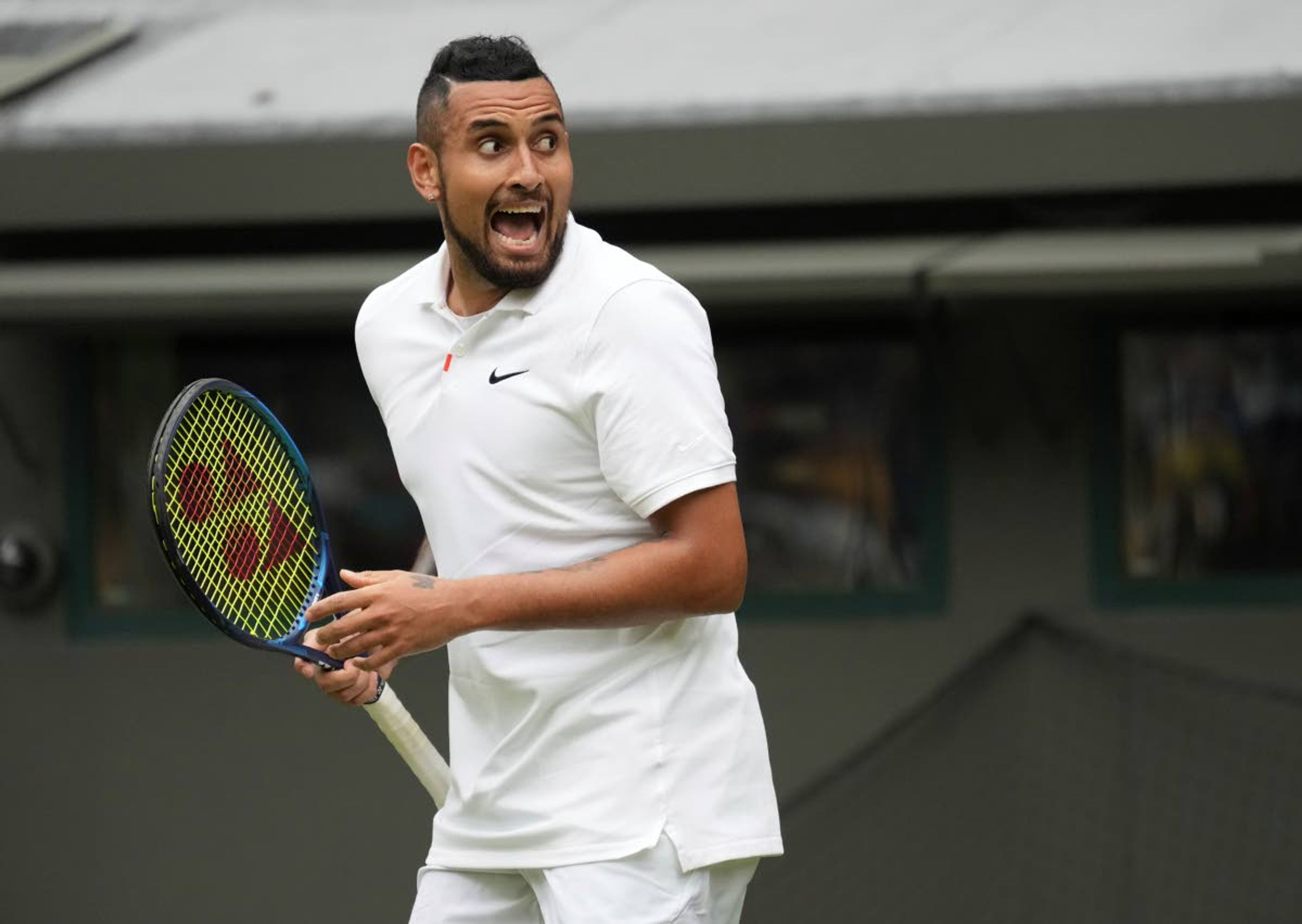 Australia's Nick Kyrgios celebrates winning the men's singles first round match against Ugo Humbert of France on day three of the Wimbledon Tennis Championships in London, Wednesday June 30, 2021. (AP Photo/Alberto Pezzali)