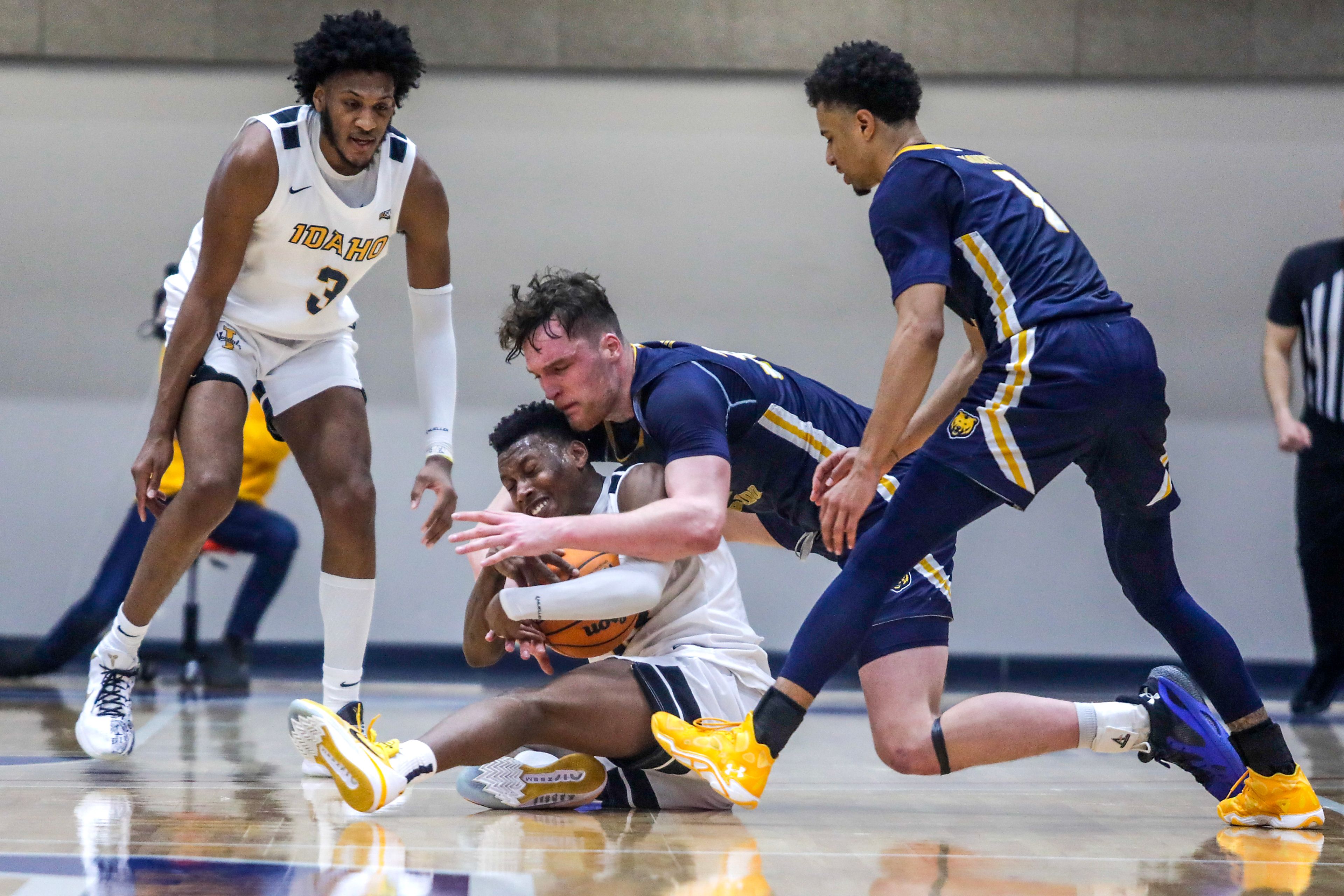 Idaho guard Divant'e Moffitt struggles for the ball with Northern Colorado center Theo Hughes in a Big Sky game at the P1FCU Activity Center on the Lewis-Clark State College campus Thursday in Lewiston.