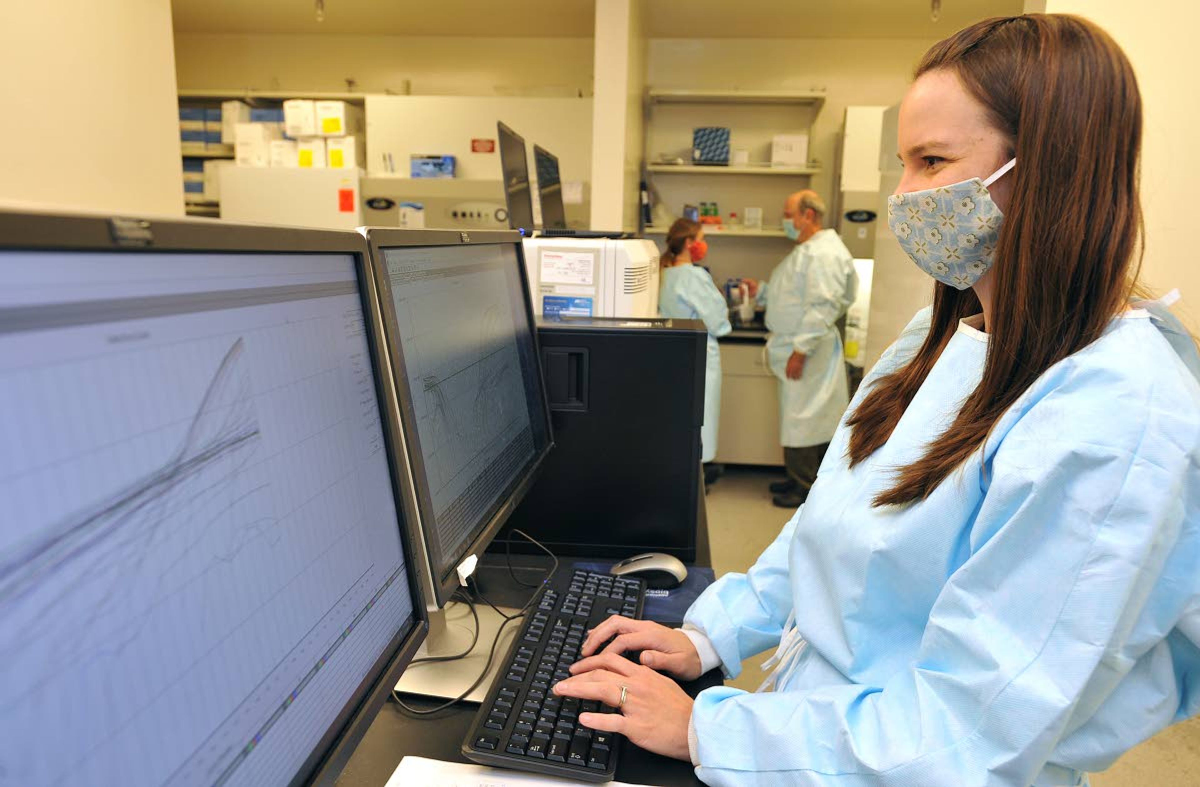 Microbiologist Becca Wolking looks at post analysis data of SARS-Cov-2 sample testing on Friday at the Washington Animal Disease Diagnostic Laboratory at Washington State University in Pullman.