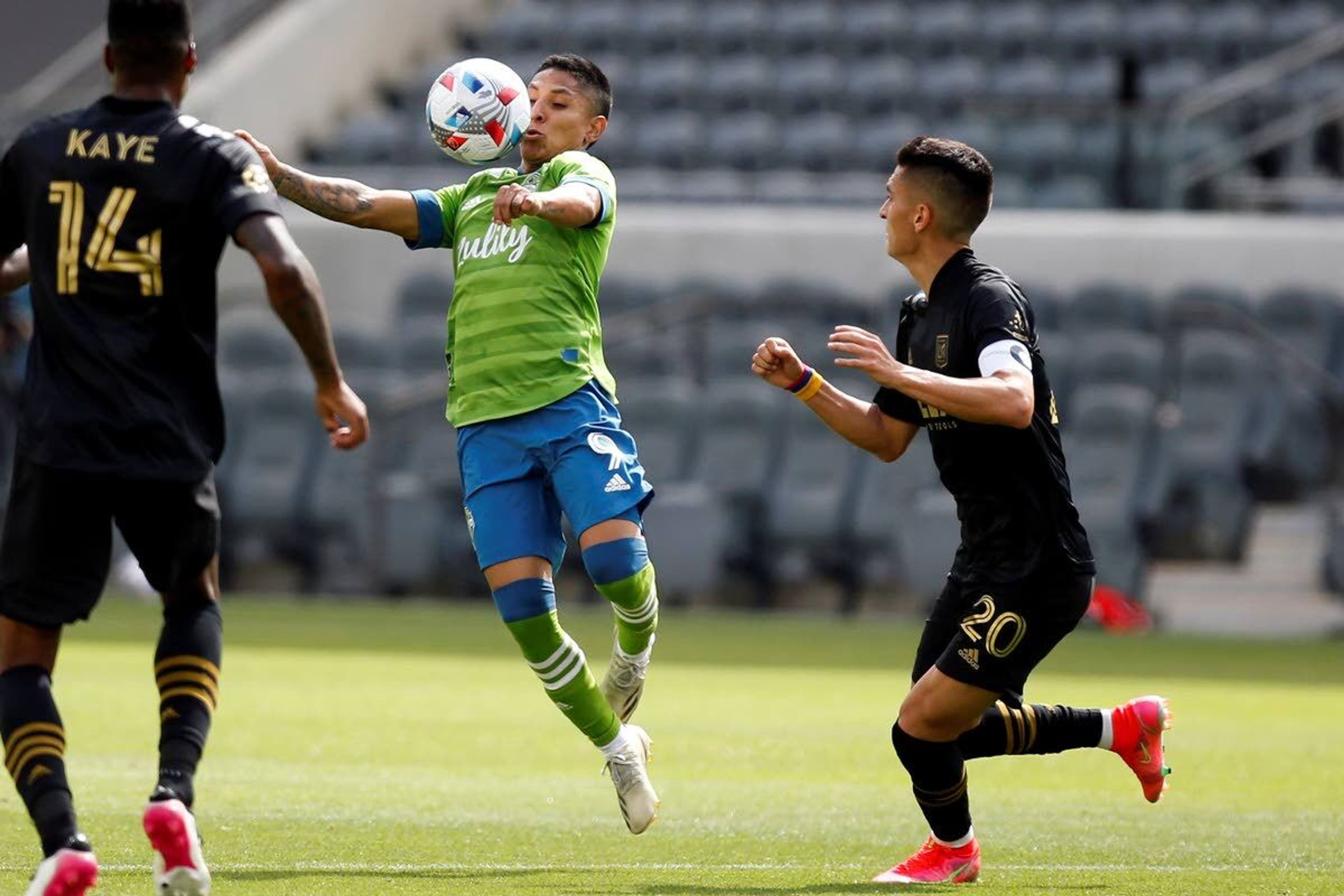 Seattle Sounders midfielder Raul Ruidiaz (9) controls the ball between Los Angeles FC midfielders Mark-Anthony Kaye (14) and Eduard Atuesta (20) during the first half of an MLS soccer match, Saturday, April 24, 2021, in Los Angeles. (AP Photo/Ringo H.W. Chiu)