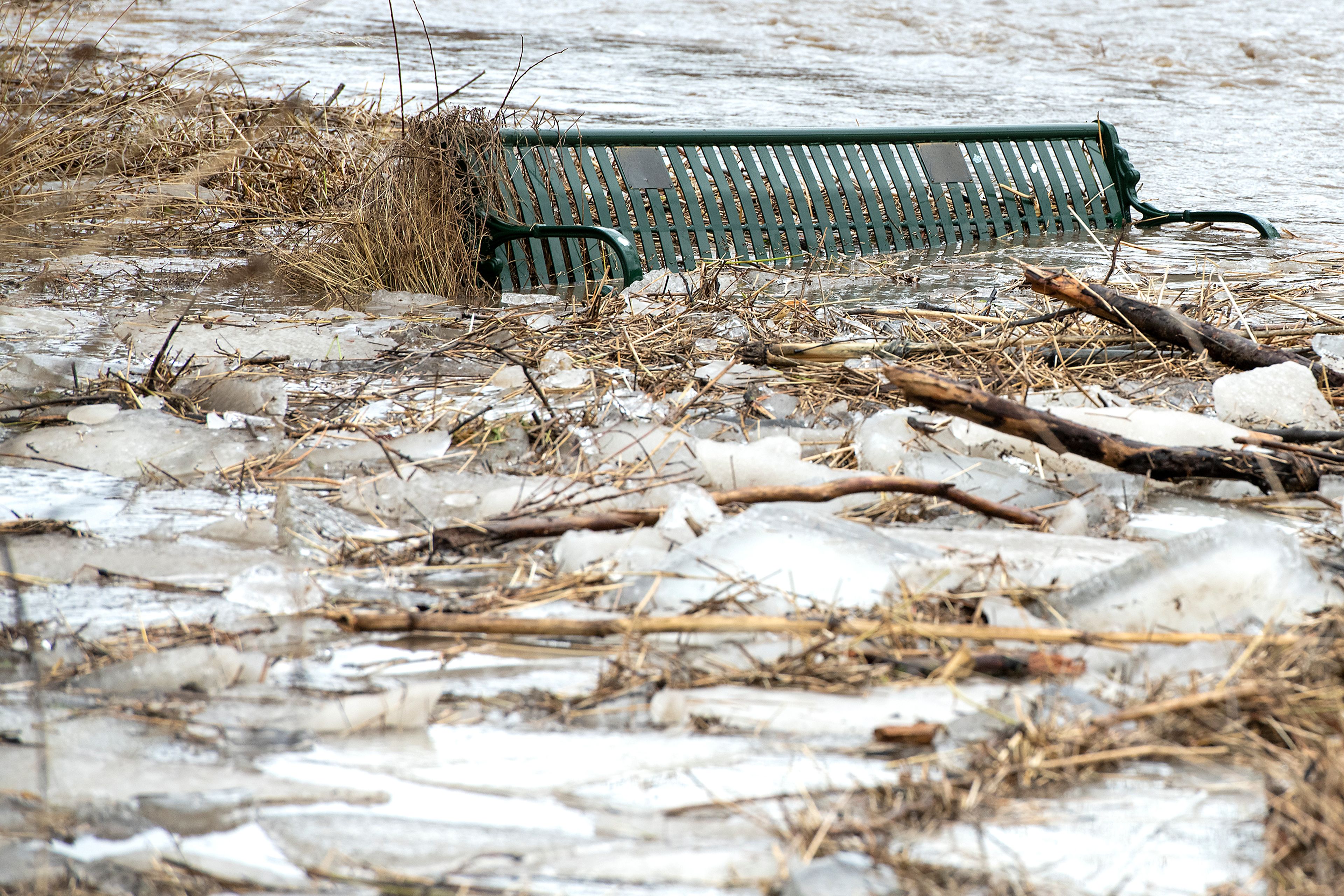 A park bench is engulfed by flooding water as chunks of ice and driftwood accumulate in the South Fork of the Palouse River in Pullman on Tuesday.