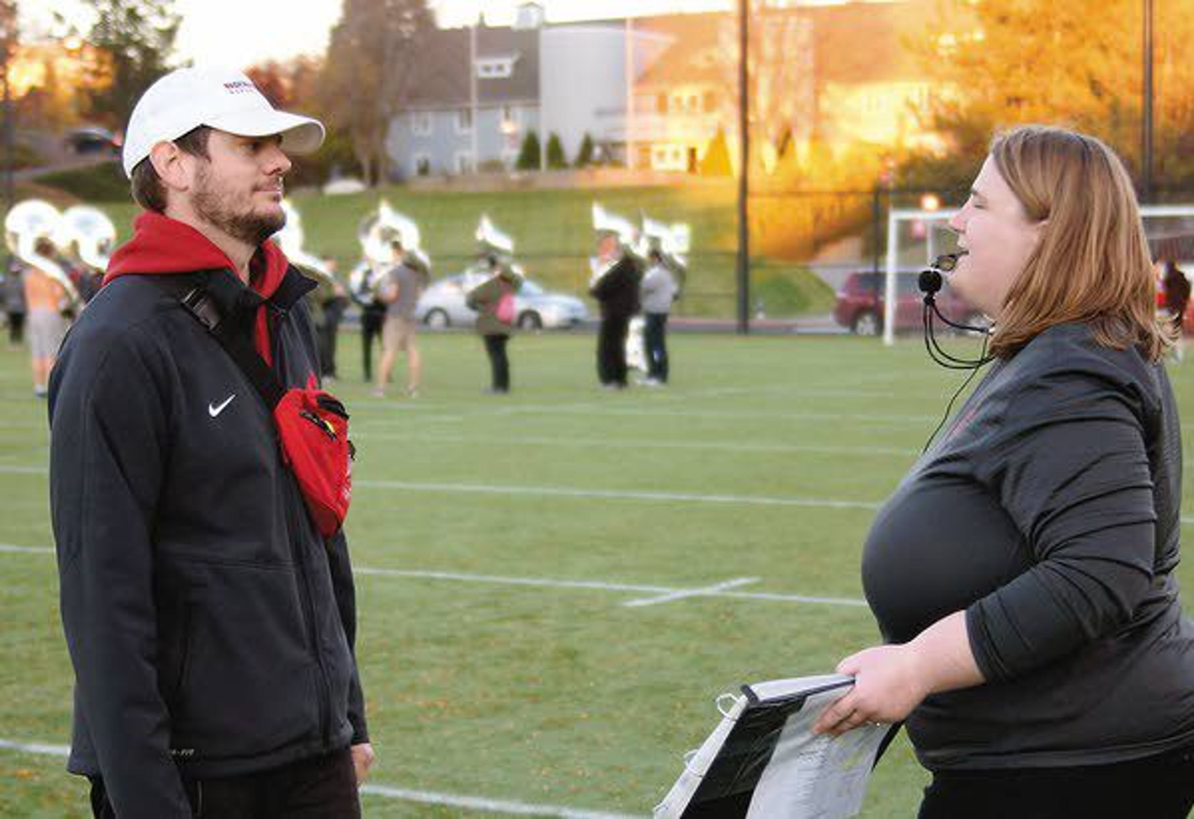 Washington State Marching Band assistant directors Brent Edwards and Sarah Miller talk during rehearsal October 24.