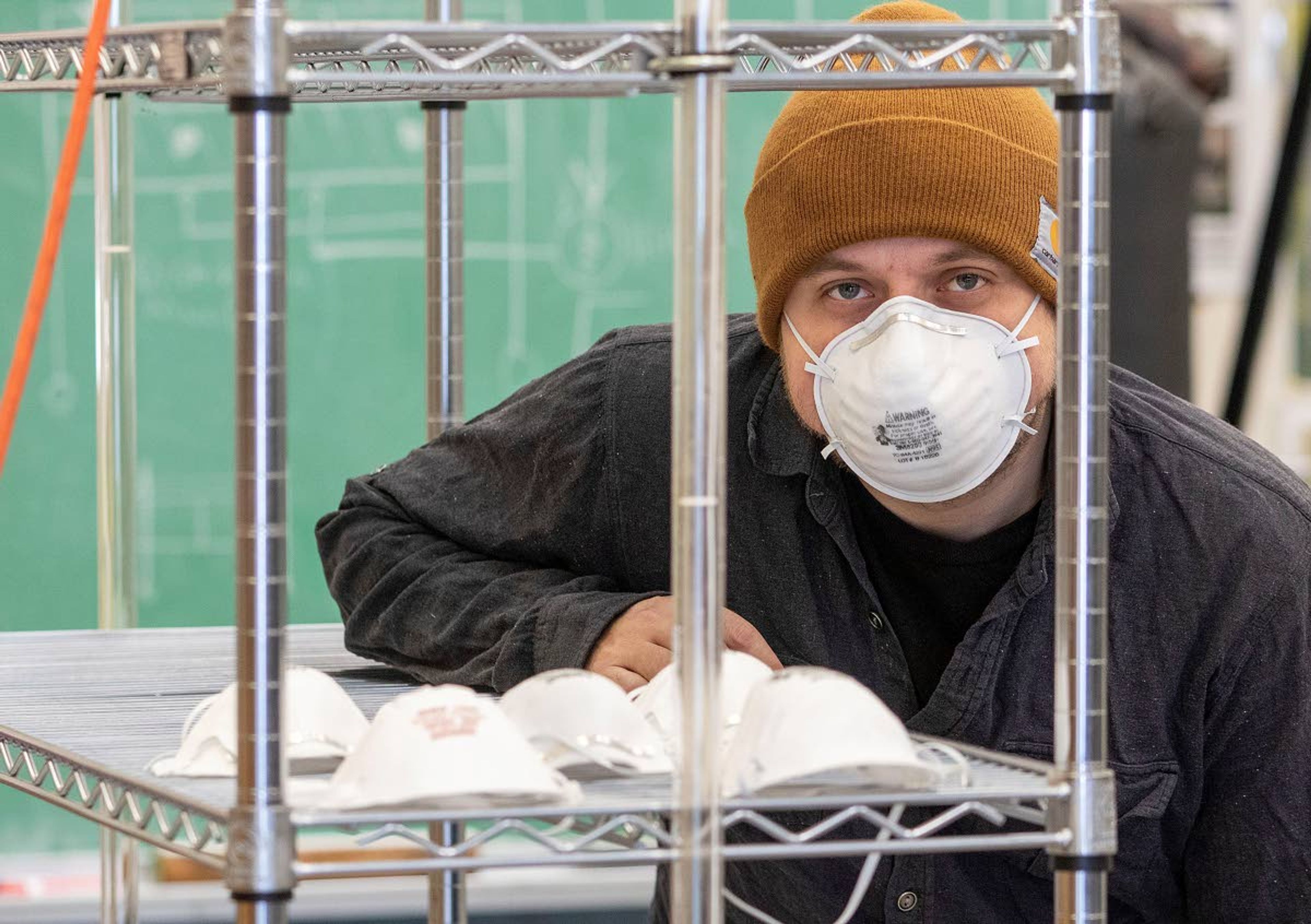 Research support scientist Chad Dunkel helps build a cabinet that uses ultraviolet light to sterilize face masks and other medical equipment at the University of Idaho Advanced Biofuel Laboratory in Moscow.