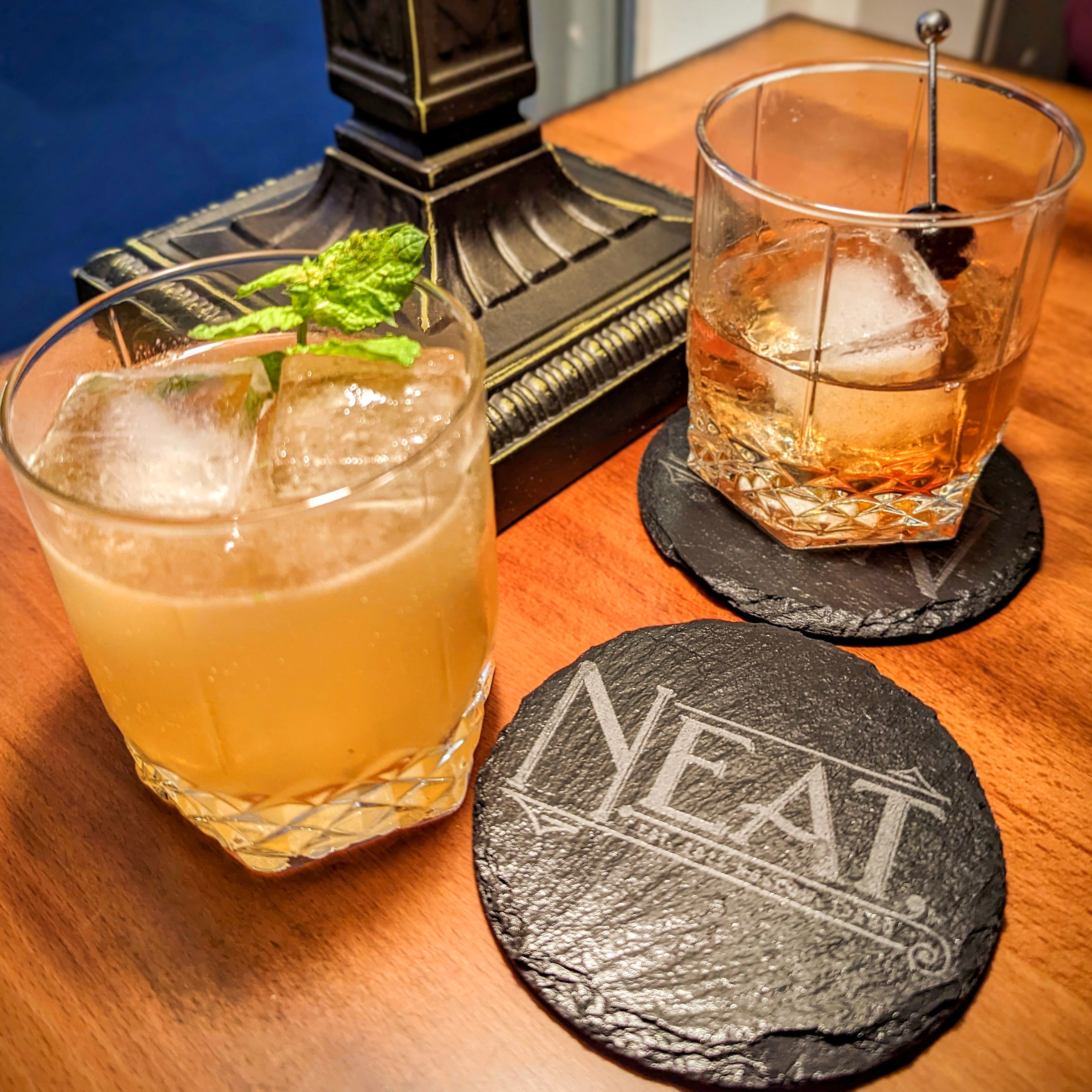 The Whiskey Smash (left) and the Improved Whiskey Cocktail (right) are popular drinks at Neat in Moscow.