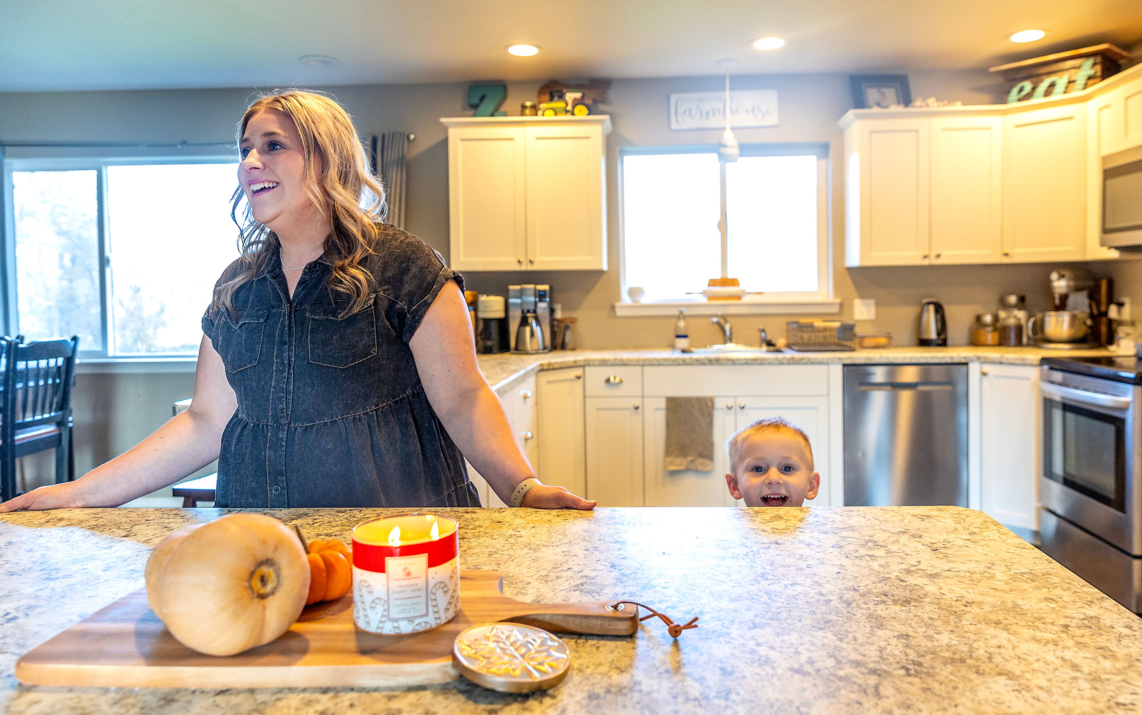 Kayla Zenner talks as her son Weston Zenner, 3, pops up from behind the counter.