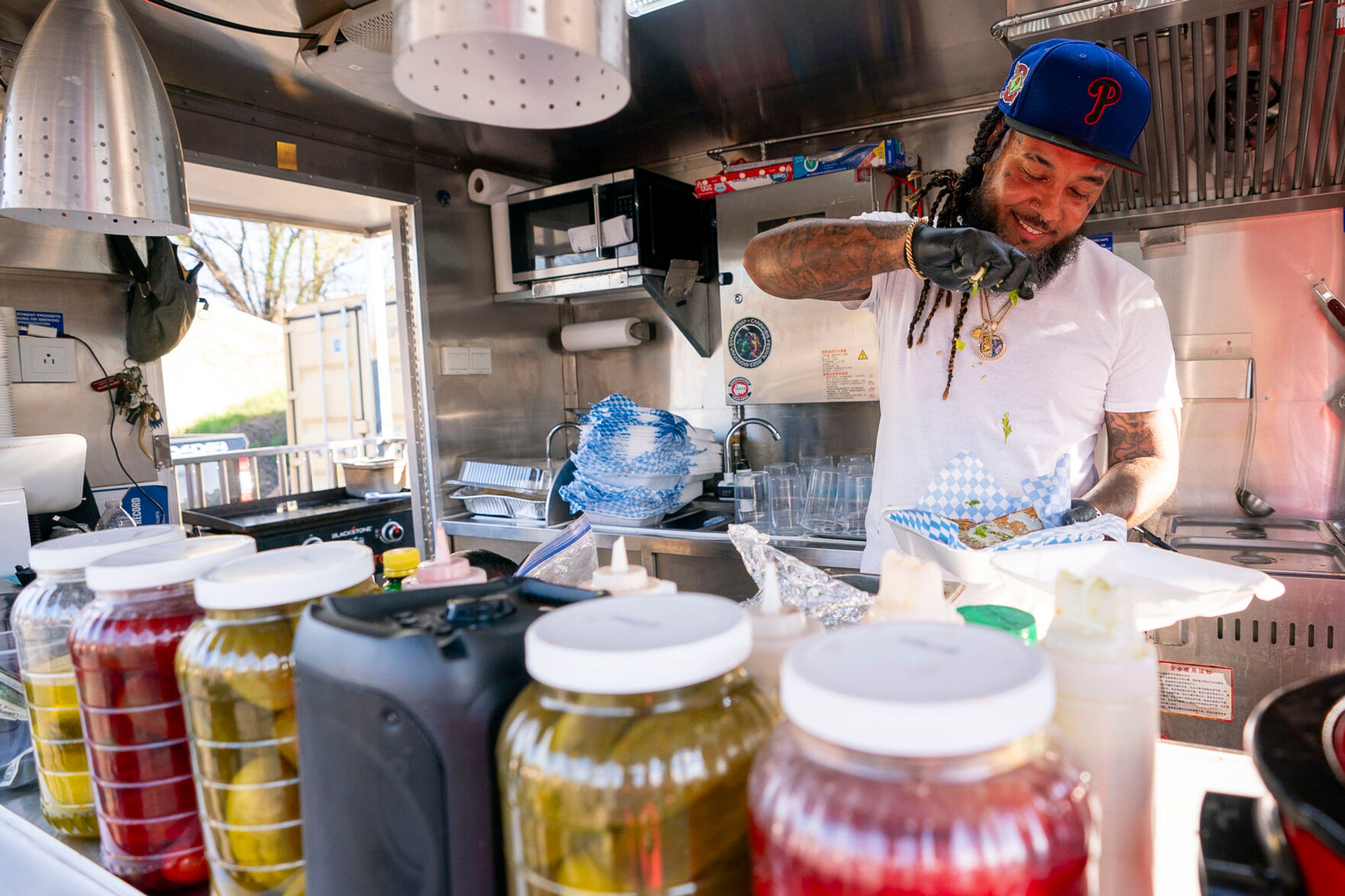 Chili Blues owner Shamar ‘Chili’ Jackson finishes off an order of “B Foldz” on Tuesday inside the food truck off of 14th Avenue in Lewiston.