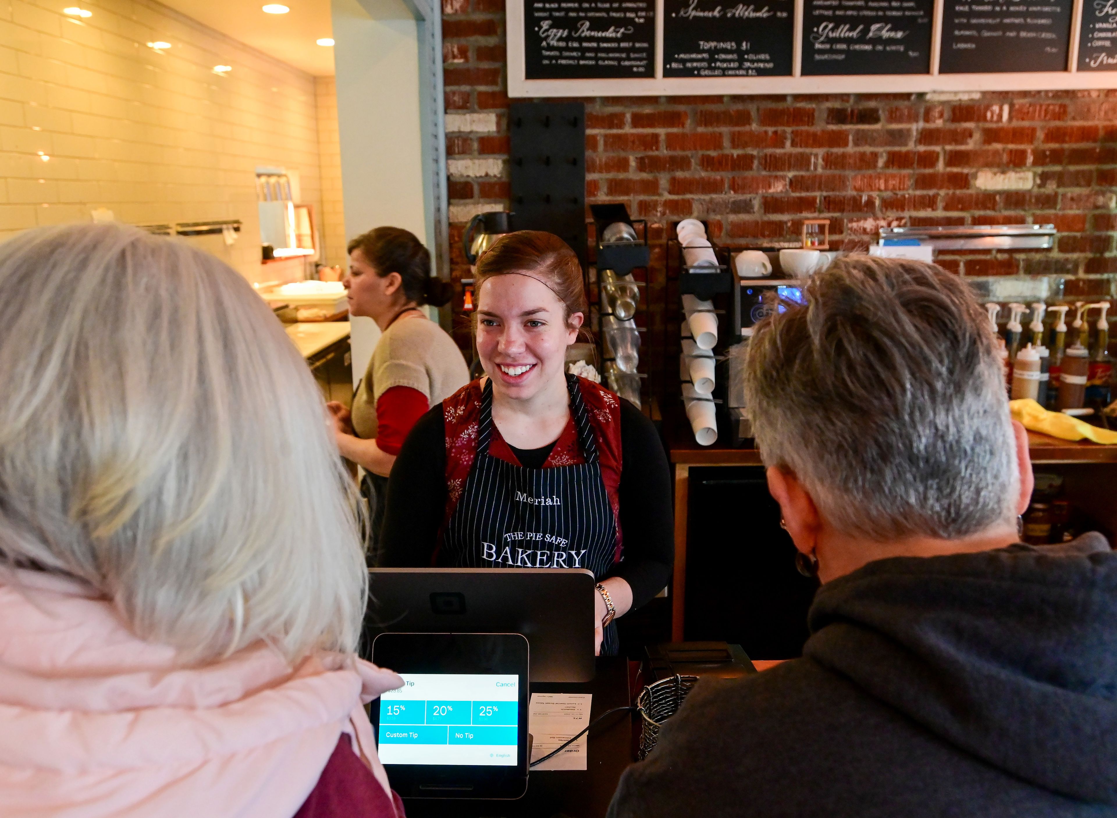 Hostess Meriah Barbieri rings up costumers at The Pie Safe Bakery in Deary on Wednesday.