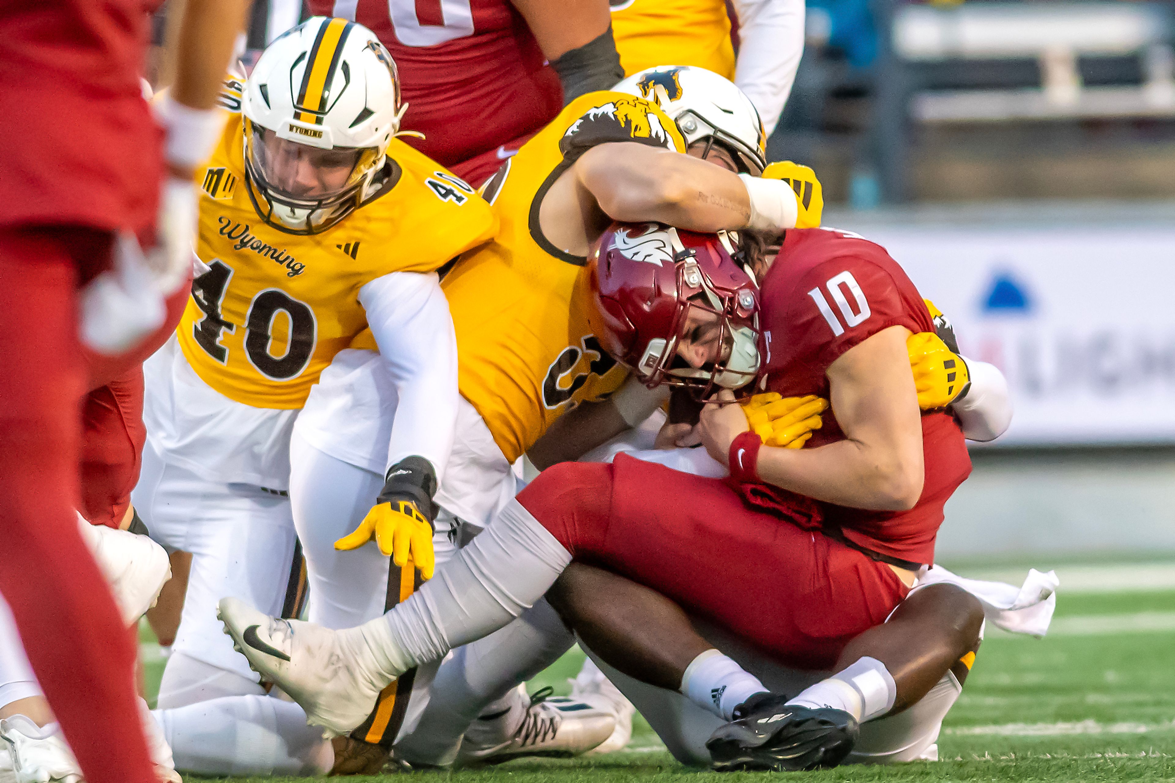 Washington State quarterback John Mateer is tackled by Wyoming linebacker Connor Shay during a quarter of a college football game on Saturday, at Gesa Field in Pullman.