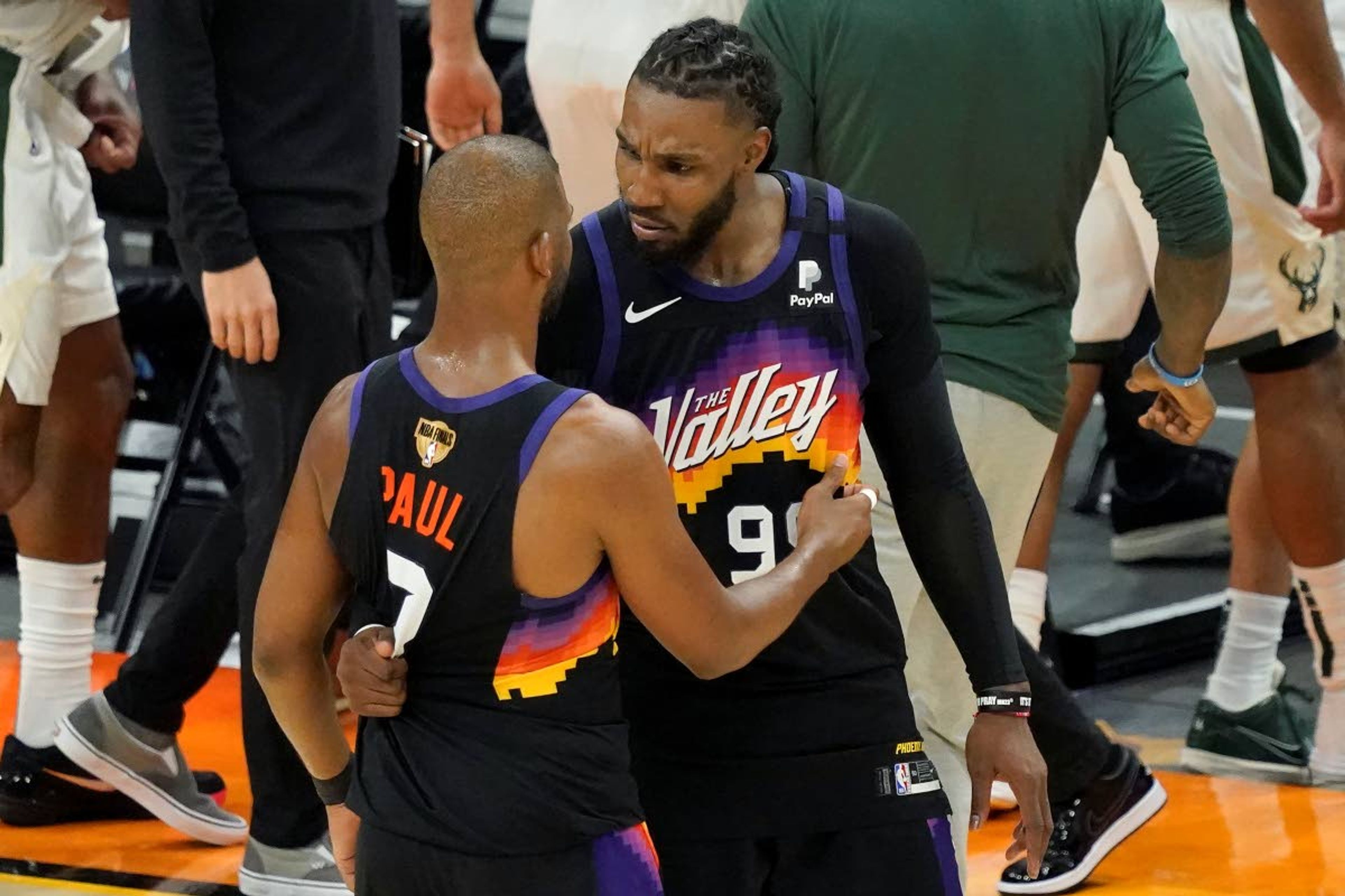 Phoenix Suns guard Chris Paul, left, celebrates with Jae Crowder after the Suns defeated the Milwaukee Bucks in Game 2 of basketball's NBA Finals, Thursday, July 8, 2021, in Phoenix. (AP Photo/Matt York)