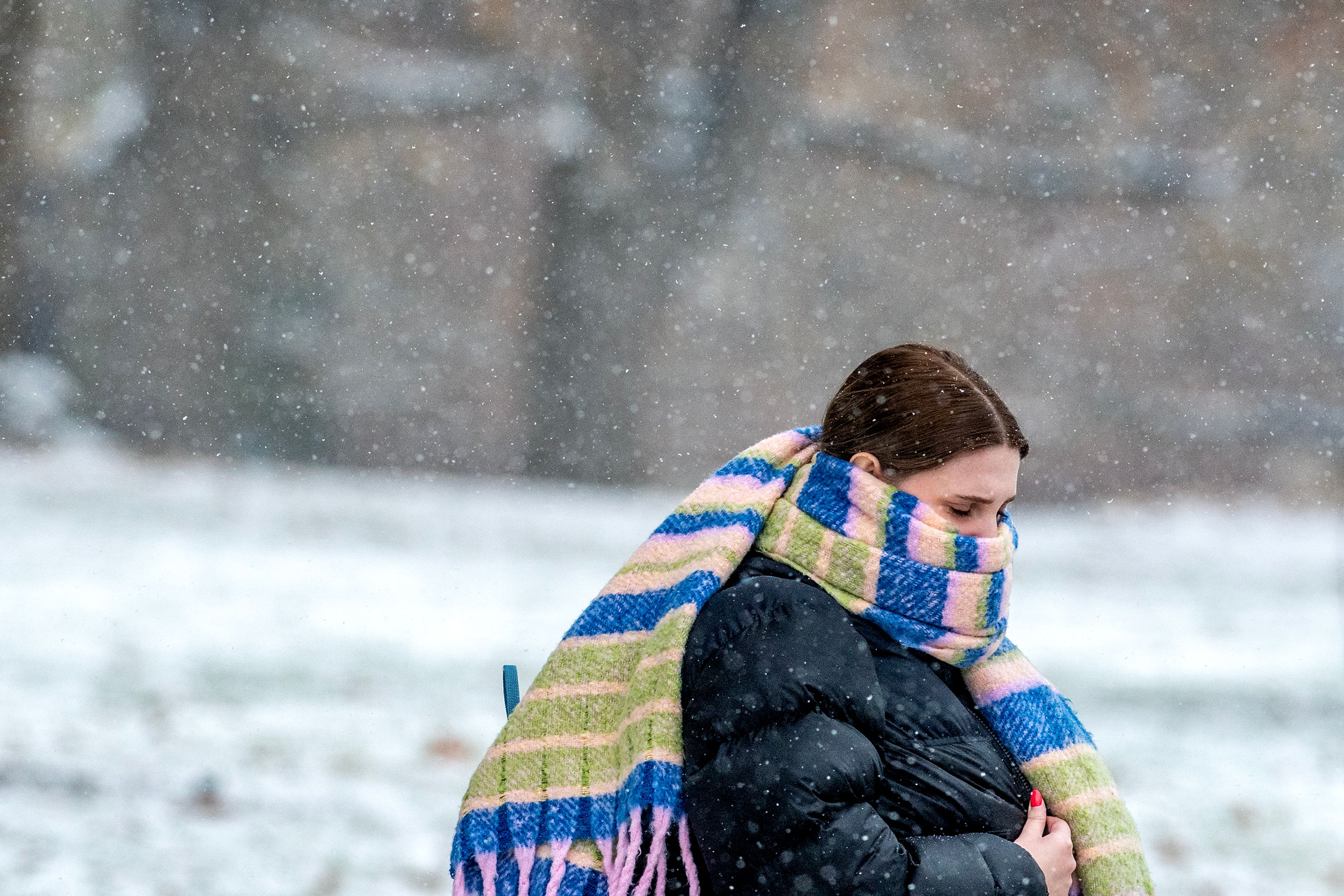 A person keeps herself bundled up for warmth as she walks through the University of Idaho campus Friday in Moscow.