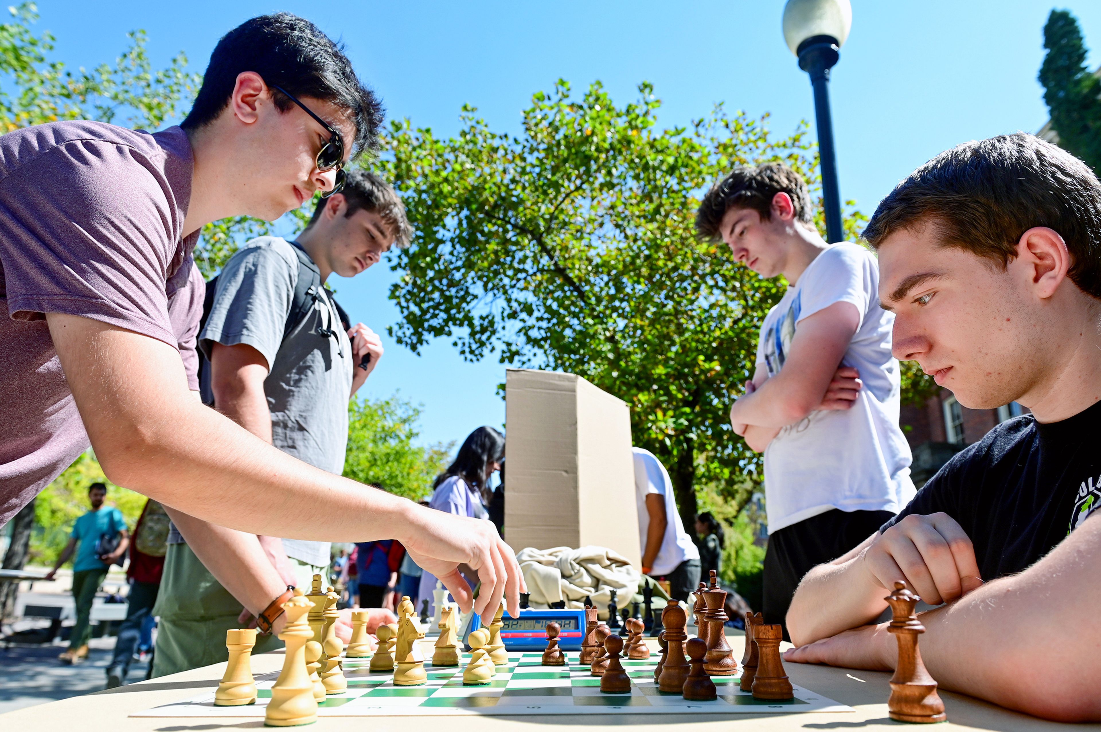 Washington State seniors Tywin Cary, from left, and Colin Mendenhall play games of chess against club Chess at WSU vice president Drew Bunch, a sophomore, and club president Brian Lee, a senior, at the Get Involved Fair Wednesday along Glenn Terrell Mall on campus in Pullman.