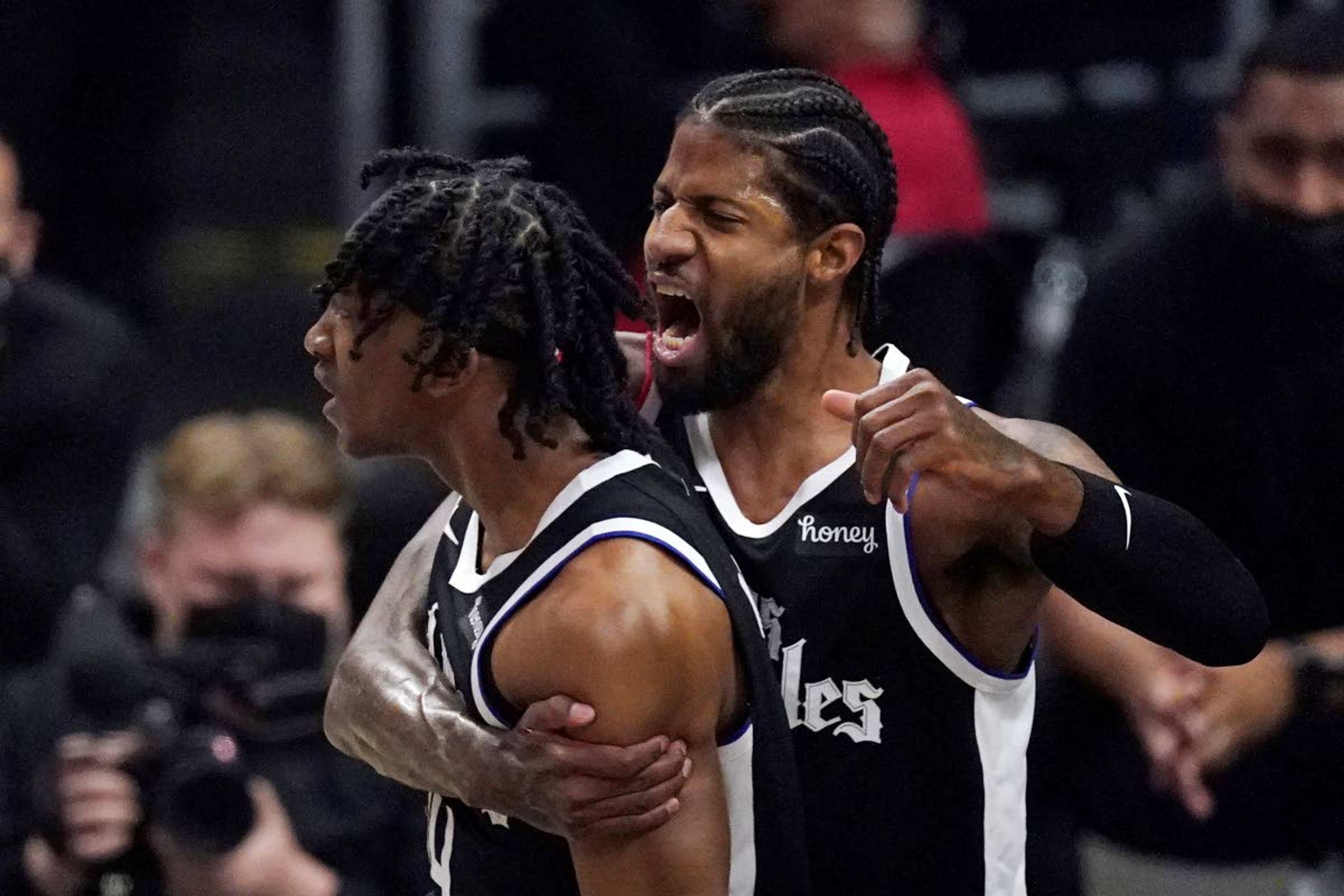 Los Angeles Clippers guard Terance Mann, left, celebrates with guard Paul George after scoring and drawing a foul during the first half in Game 6 of a second-round NBA basketball playoff series against the Utah Jazz Friday, June 18, 2021, in Los Angeles. (AP Photo/Mark J. Terrill)