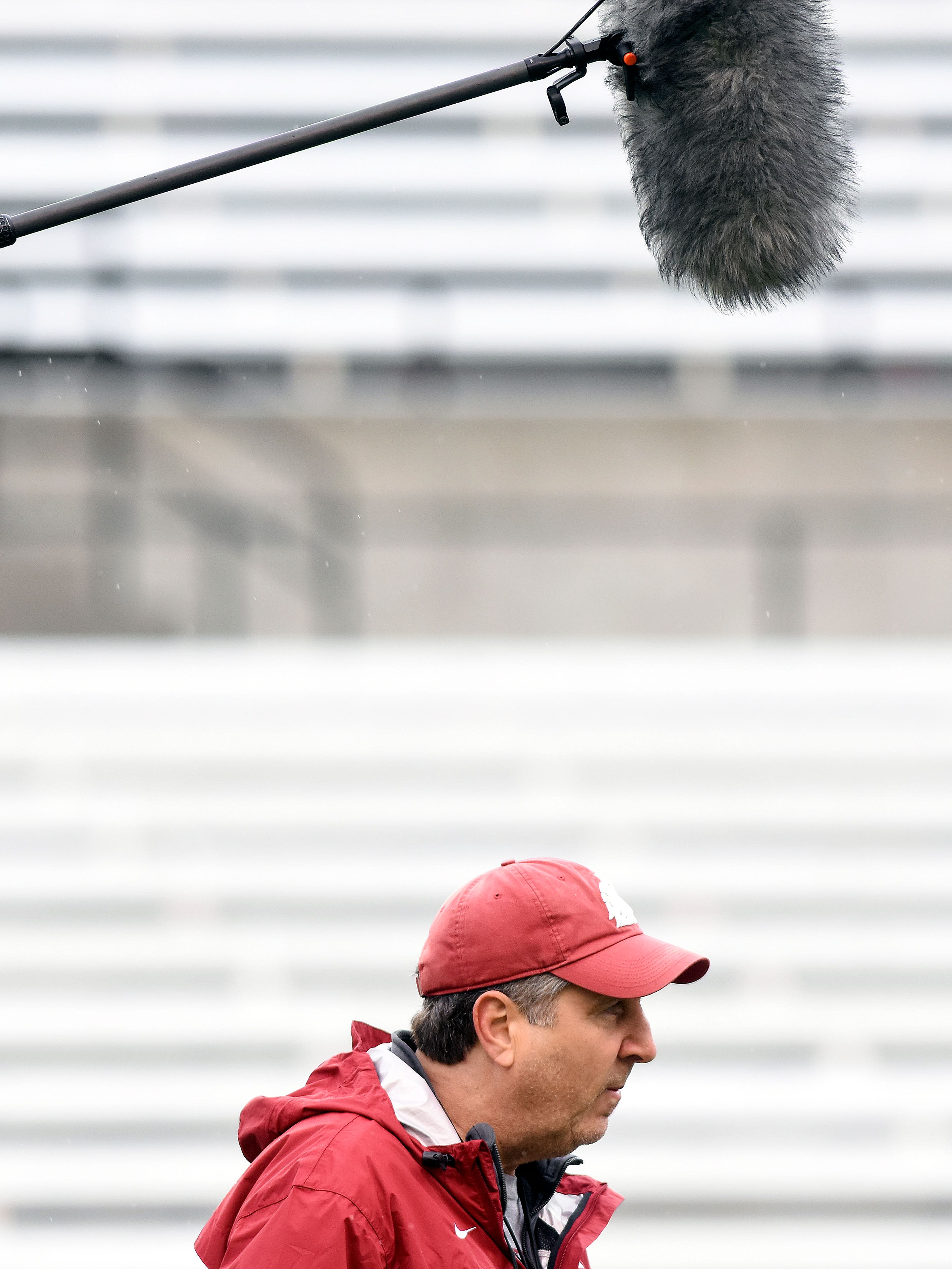 A microphone hovers over the head of Washington State head coach Mike Leach as a film crew from ESPN follows him around during spring practice on Thursday, March 22, 2018, at Martin Stadium in Pullman.