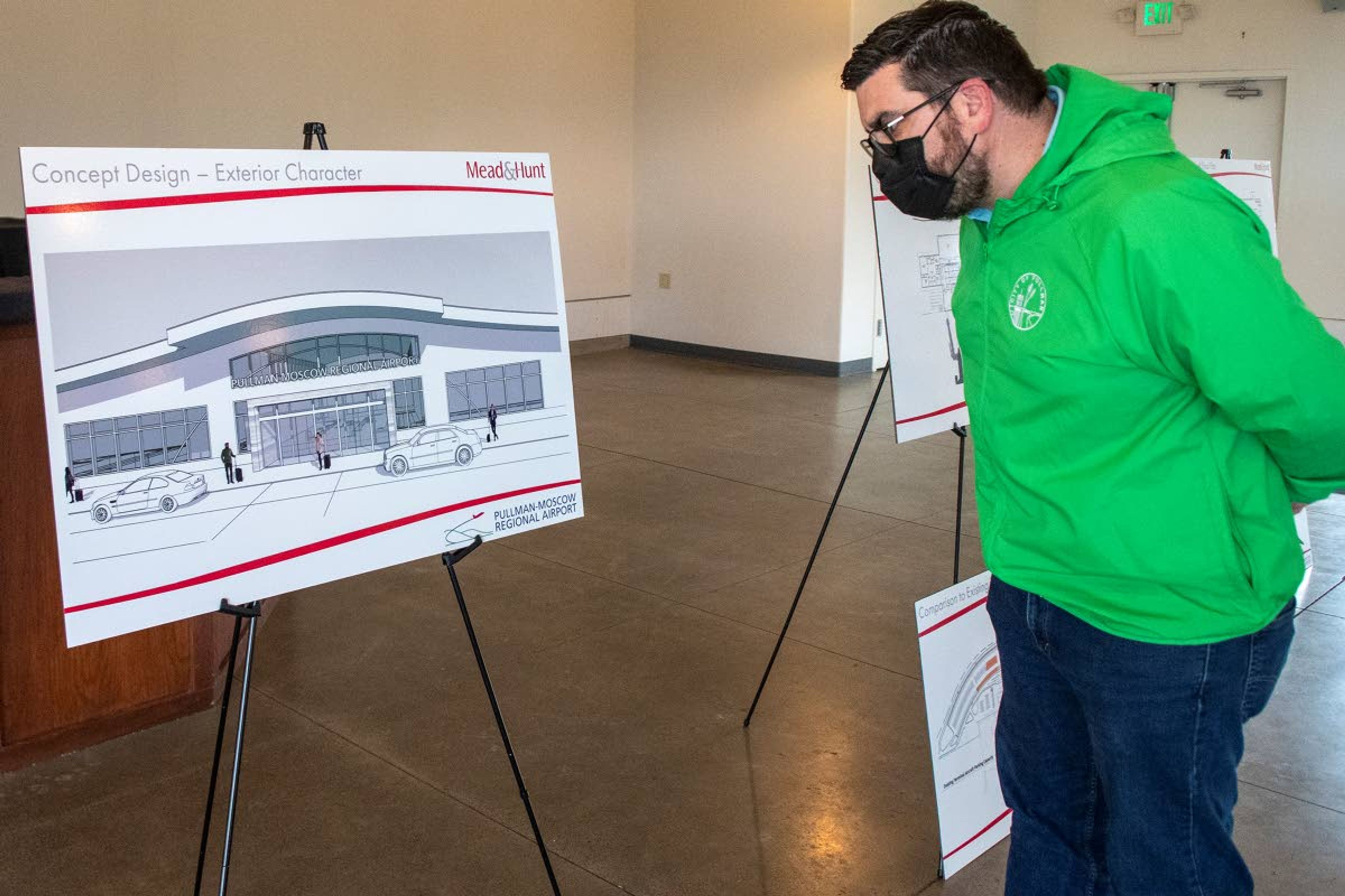 In this file photo from April, Pullman City Council Member Brandon Chapman views an exterior concept design of Pullman-Moscow Regional Airport’s new passenger terminal at the Round Top Public House in Pullman.