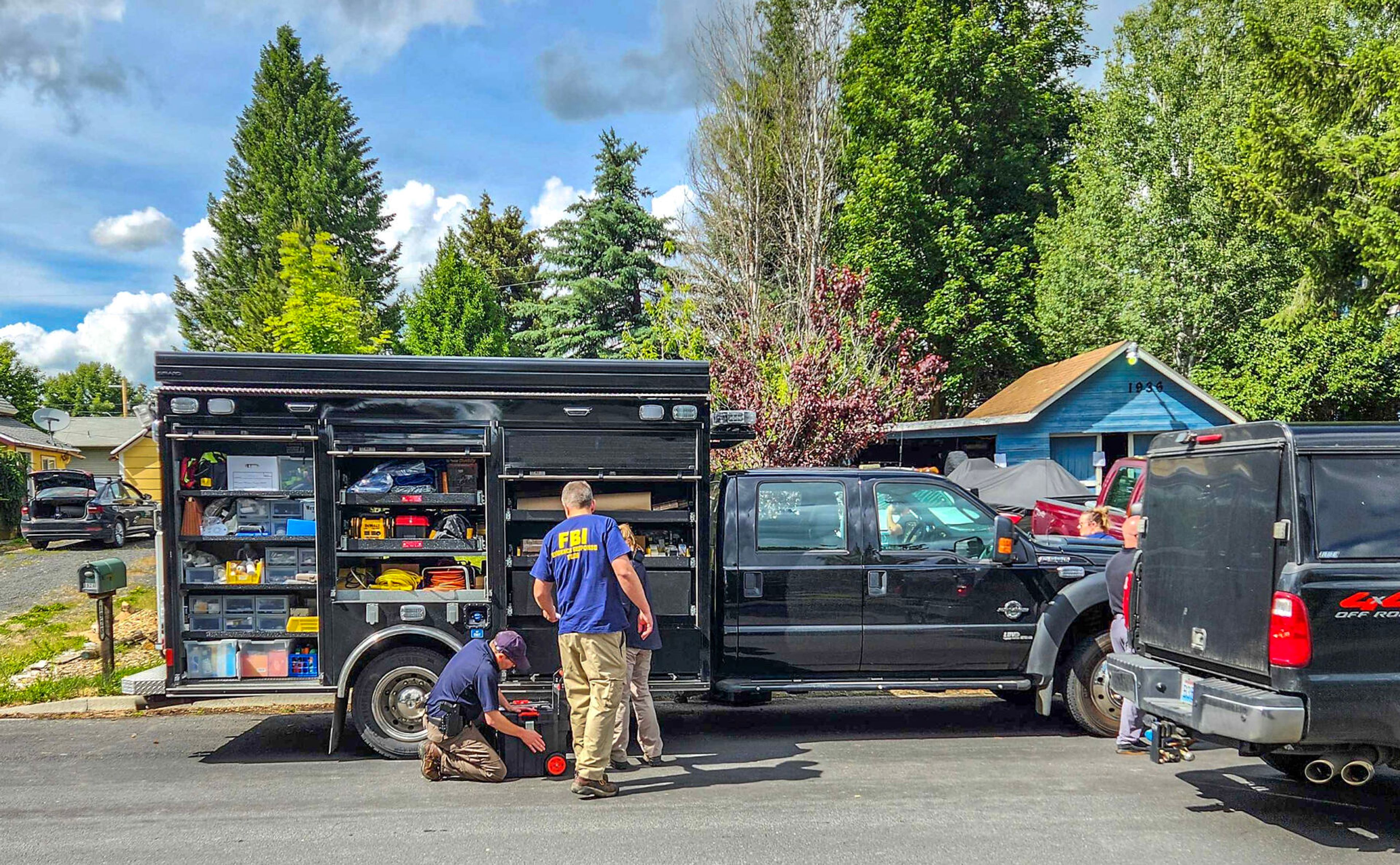 Officers from the FBI search a house along the 1900 block of F Street in Moscow.