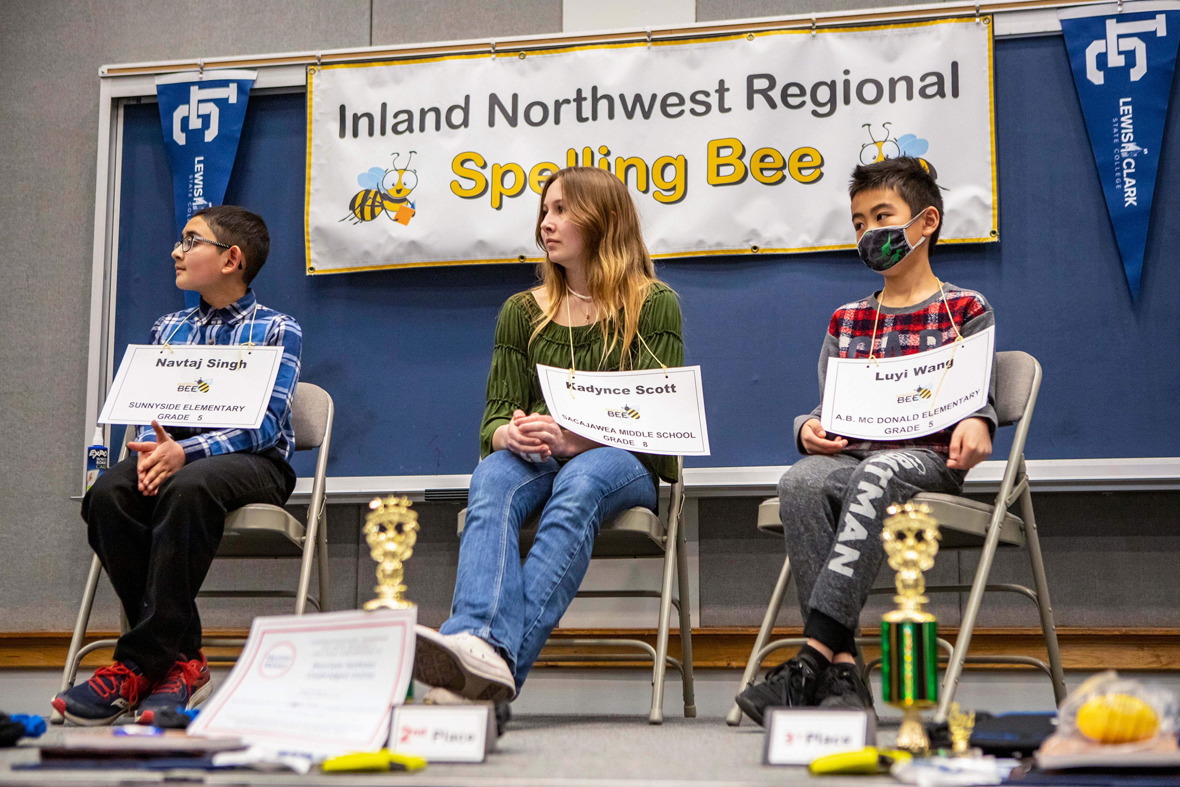 Austin Johnson/Daily News The top three finalists of the Inland Northwest Spelling Bee take to the podium Saturday after going 17 rounds at Williams Conference Center located on the Lewis-Clark State College campus. Navtaj Singh, left, of Sunnyside Elementary in Pullman came in first, Kadynce Scott of Sacajawea Middle School in Lewiston came in second, and Luyi Wang of A.B. McDonald Elementary in Moscow came in third.