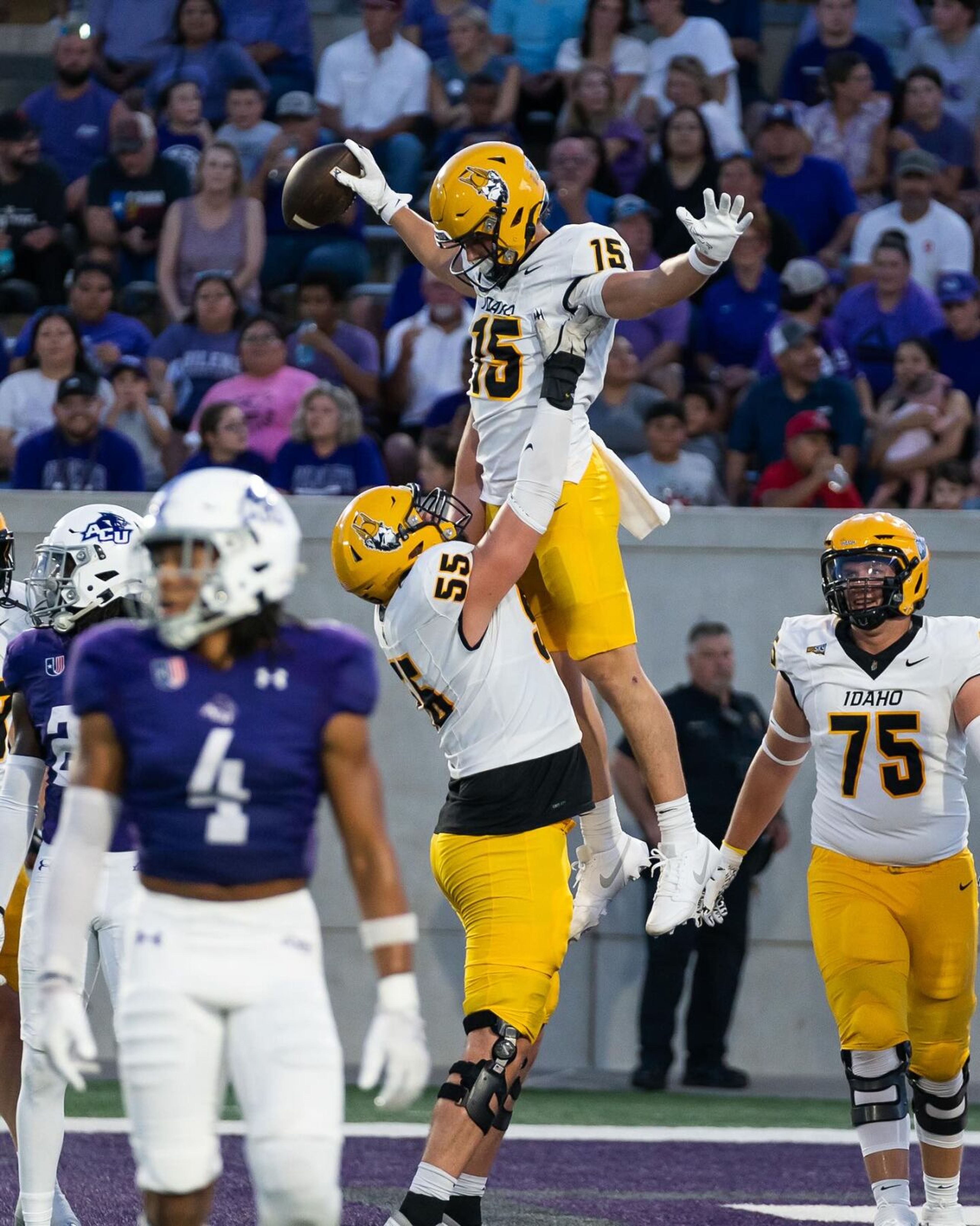 Idaho offensive lineman Jack Foster (55) lifts wide receiver Mark Hamper (15) into the air to celebrate Hamper's touchdown while offensive lineman Ayden Knapik (75) looks on during a game against Abilene Christian on Saturday, Sept. 21, 2024, in Abilene, Texas.