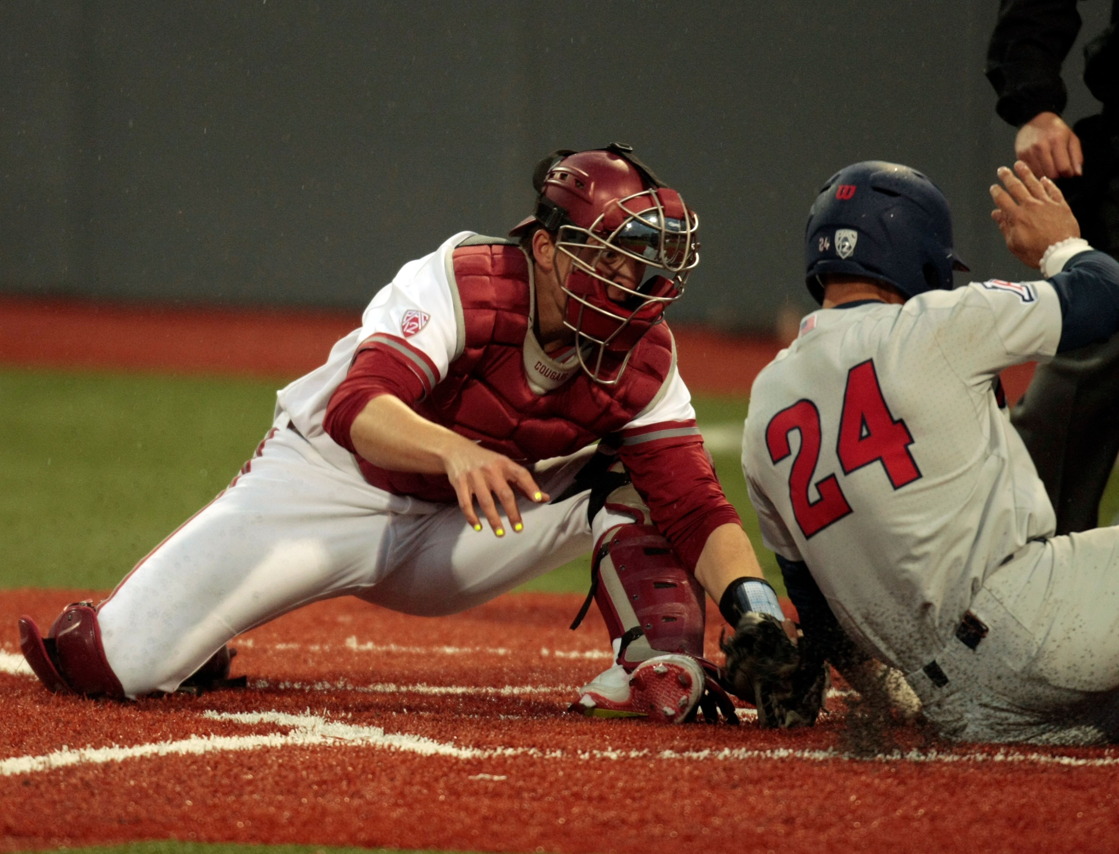 Washington State catcher cal water tries, unsuccessfully, to tag Arizona's JJ Matijevic at the plate during a PAC-12 game at Bailey Brayton Field on Friday evening.