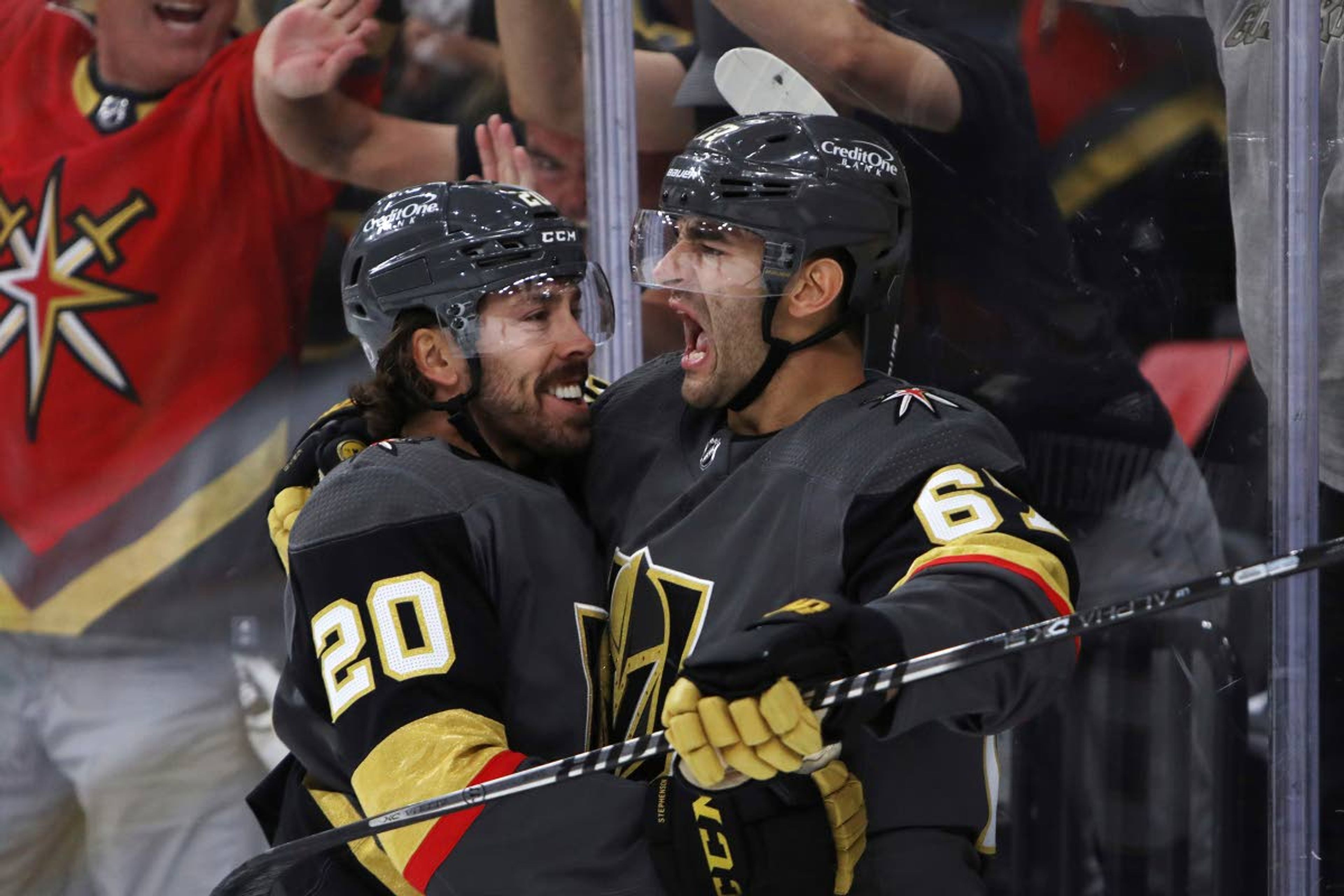 Vegas Golden Knights center Chandler Stephenson (20) cheers on left wing Max Pacioretty (67), who scored a goal against the Minnesota Wild during the second period of Game 7 of an NHL hockey Stanley Cup first-round playoff series Friday, May 28, 2021, in Las Vegas. (AP Photo/Joe Buglewicz)