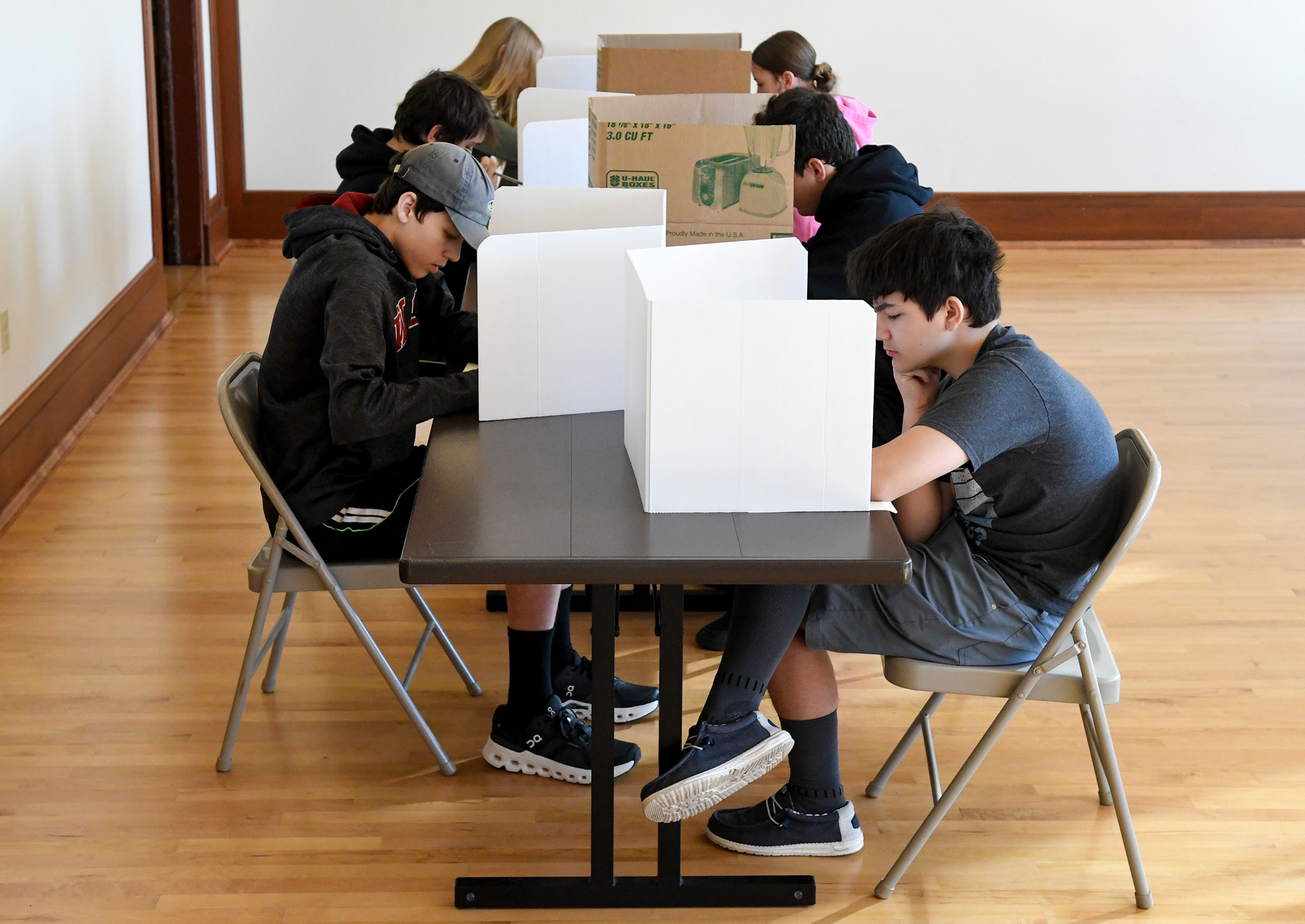 Moscow High School students sit at makeshift polling stations Wednesday to take part in a mock election hosted by the League of Women Voters of Moscow at the 1912 Center in Moscow.