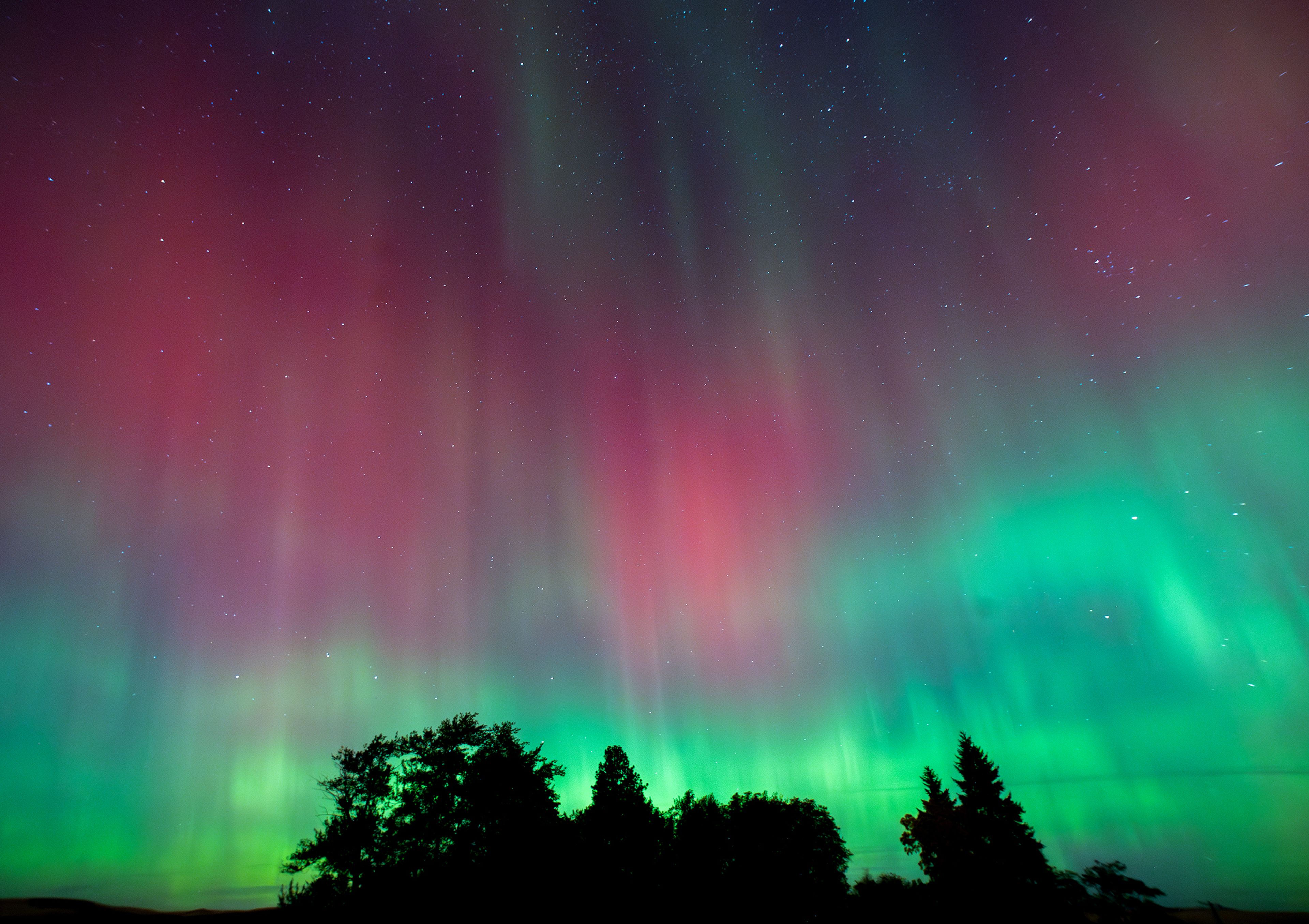 An active aurora borealis fills the night sky Thursday from a viewpoint along Kamiak Butte Park Road between Palouse and Pullman. The aurora forms fine pleats in the auroral curtain categorized as rayed arcs, or vertical stripes and striations, when it becomes more active, according to the University of Alaska Fairbanks Geophysical Institute.