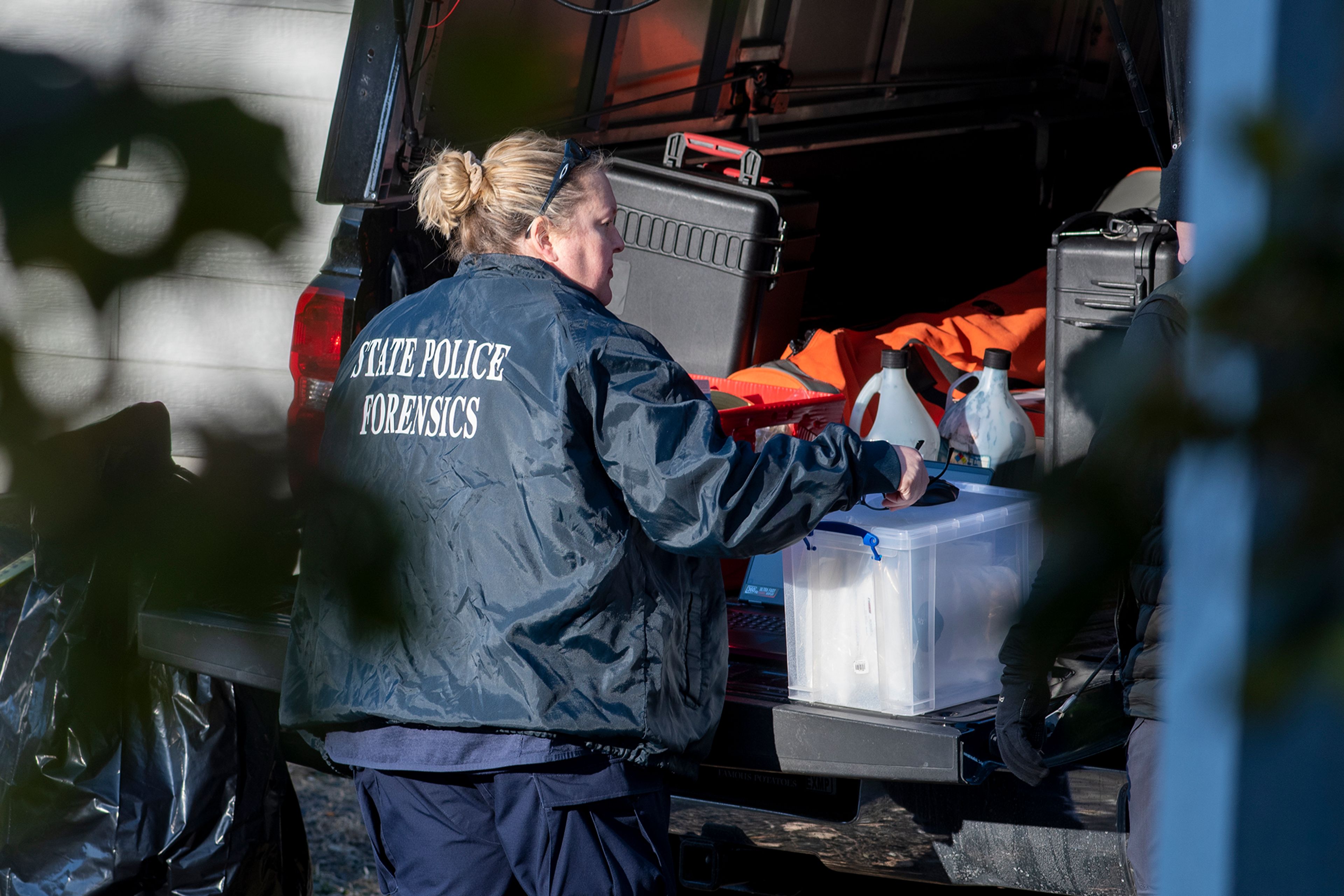 A member of the Idaho State Police forensic team investigates Friday at a home where four University of Idaho students were recently murdered over the weekend in Moscow.