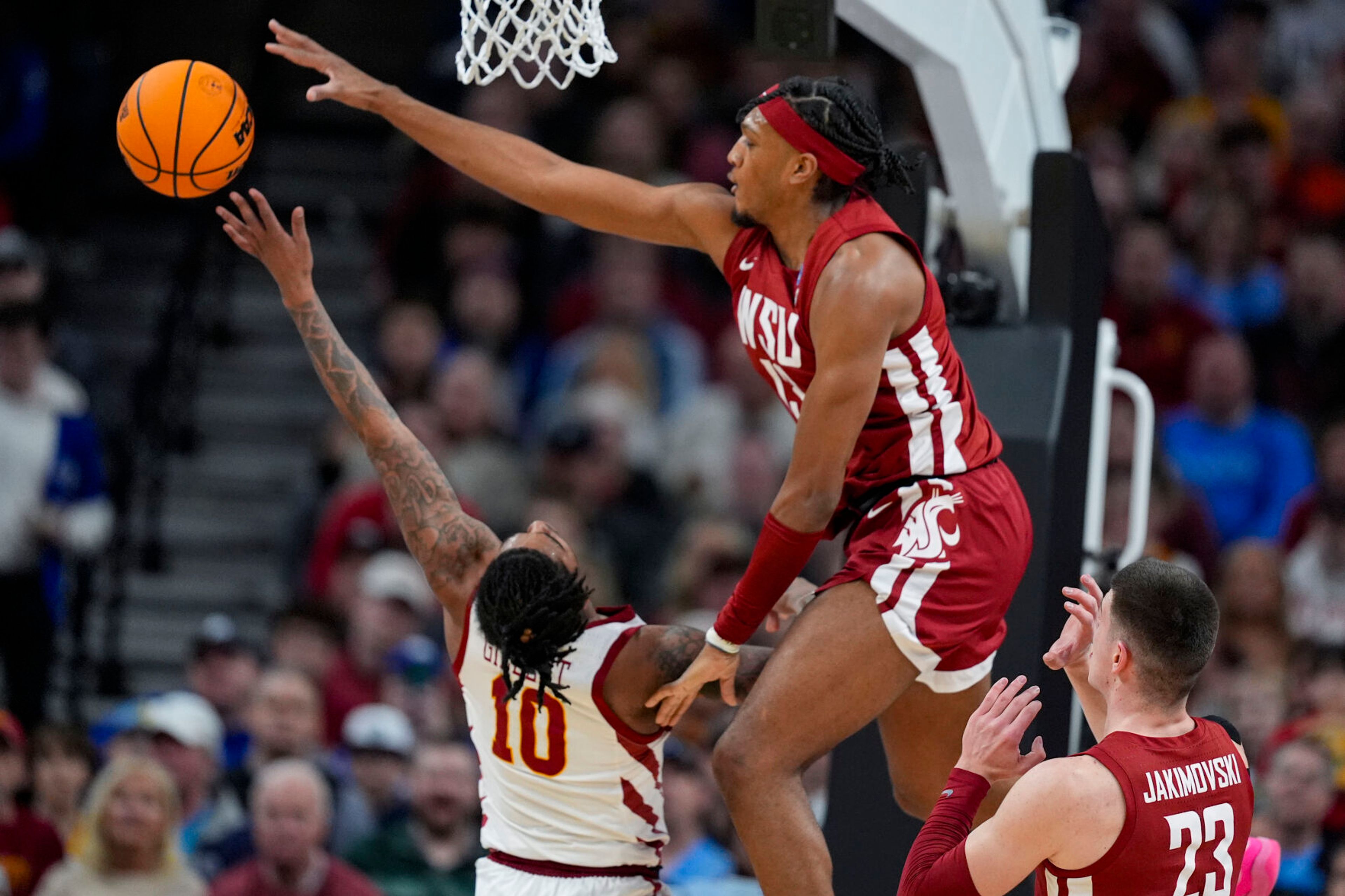 Washington State forward Isaac Jones (13) blocks the shot of Iowa State guard Keshon Gilbert (10) in a second-round game in the NCAA tournament Saturday in Omaha, Neb.