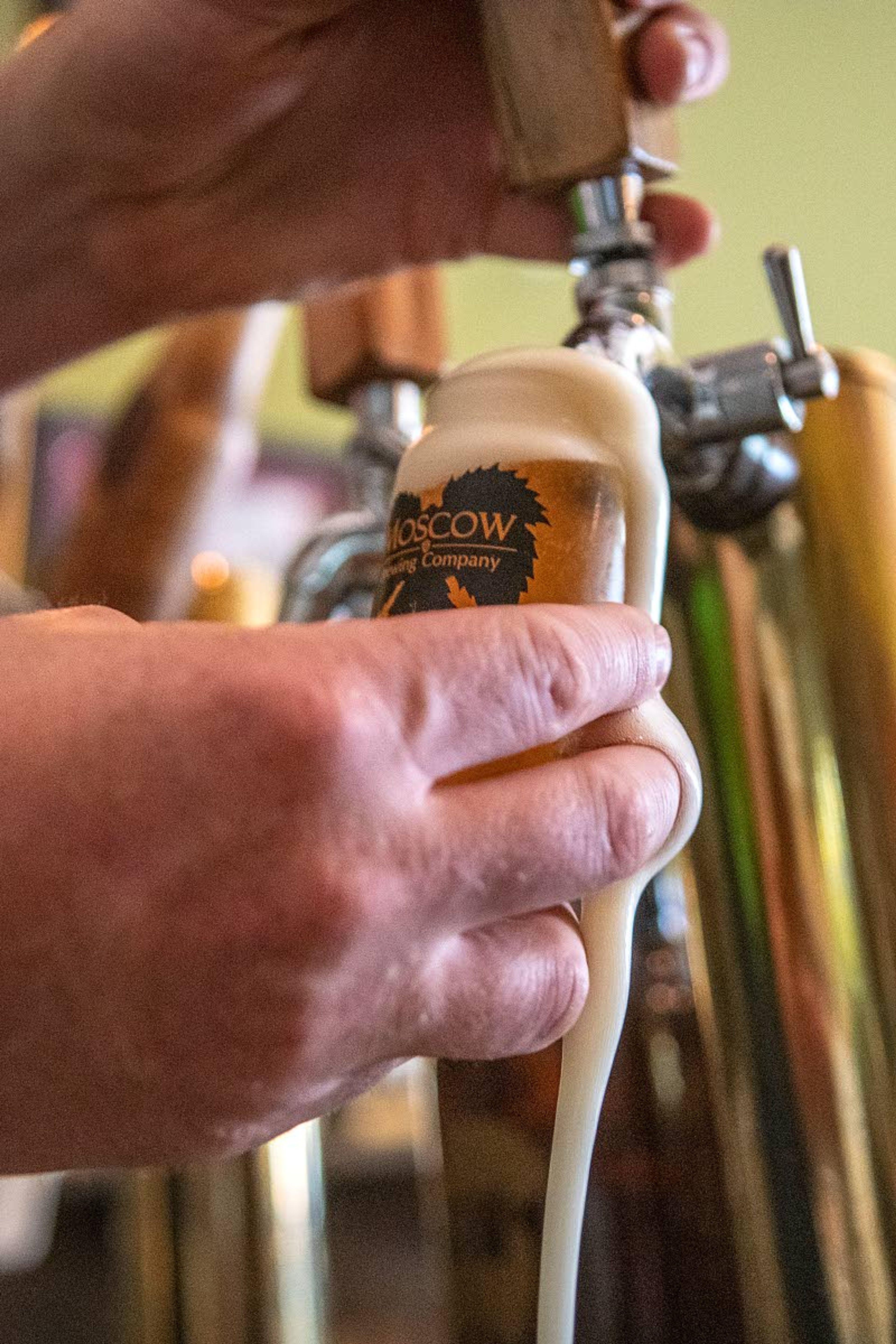 Owner Aaron Hart pours a sample sized beer to include in a flight of beer at Moscow Brewing Company.