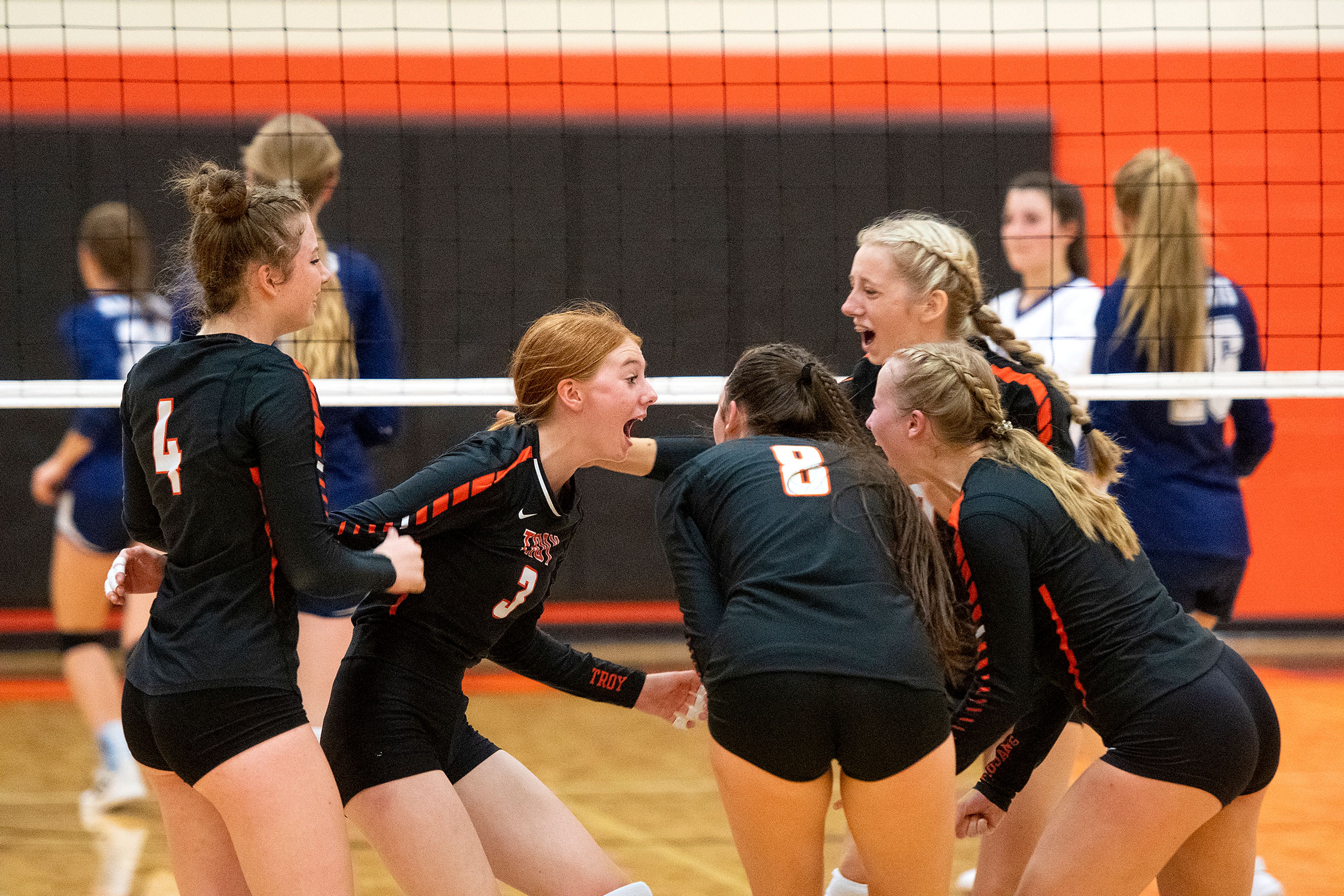 Troy players celebrate after scoring against Logos during a Whitepine League matchup Tuesday at Troy High School.