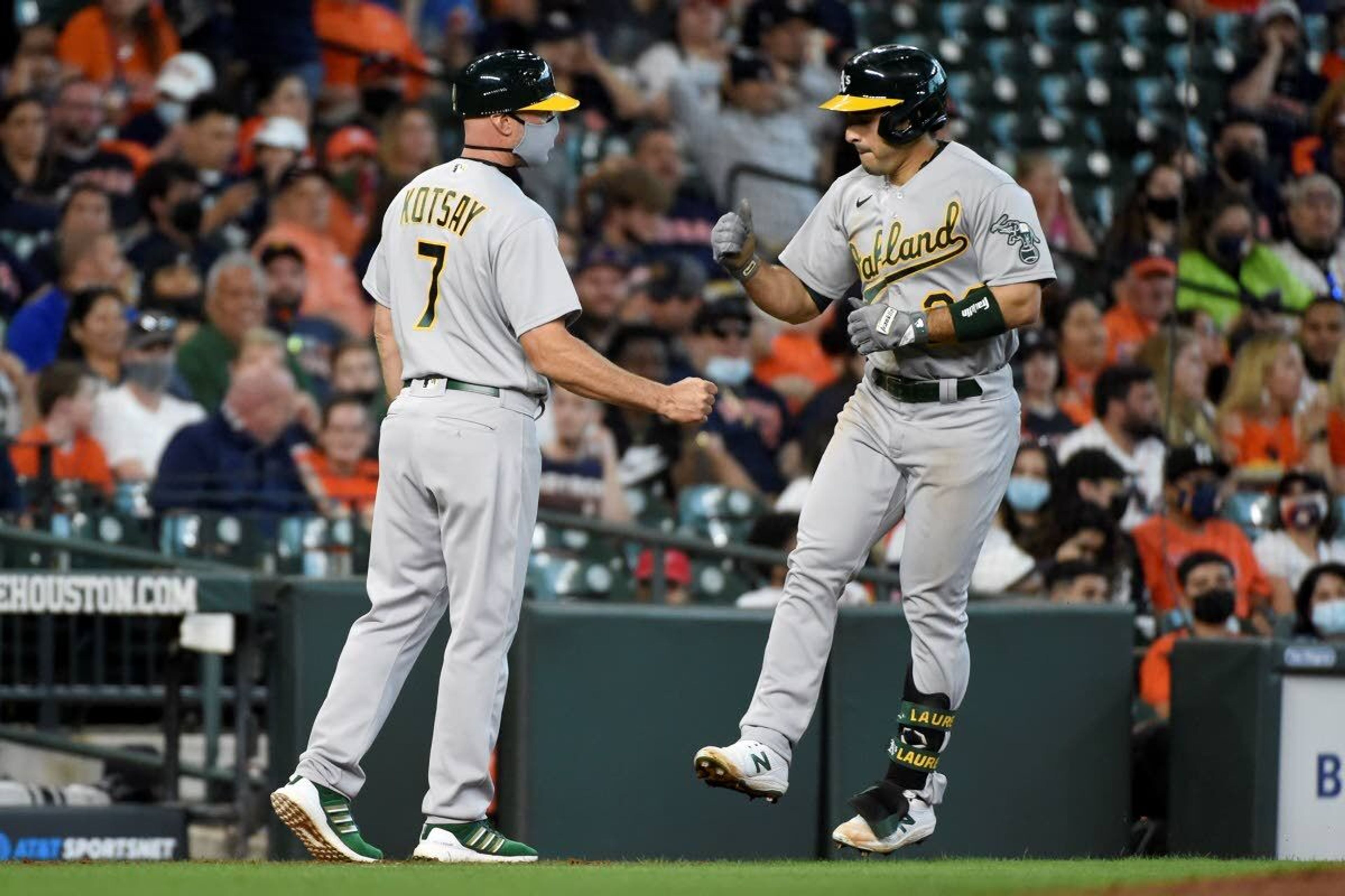 Oakland Athletics' Ramon Laureano, right, celebrates his two-run home run with third base coach Mark Kotsay during the fifth inning of a baseball game against the Houston Astros, Saturday, April 10, 2021, in Houston. (AP Photo/Eric Christian Smith)