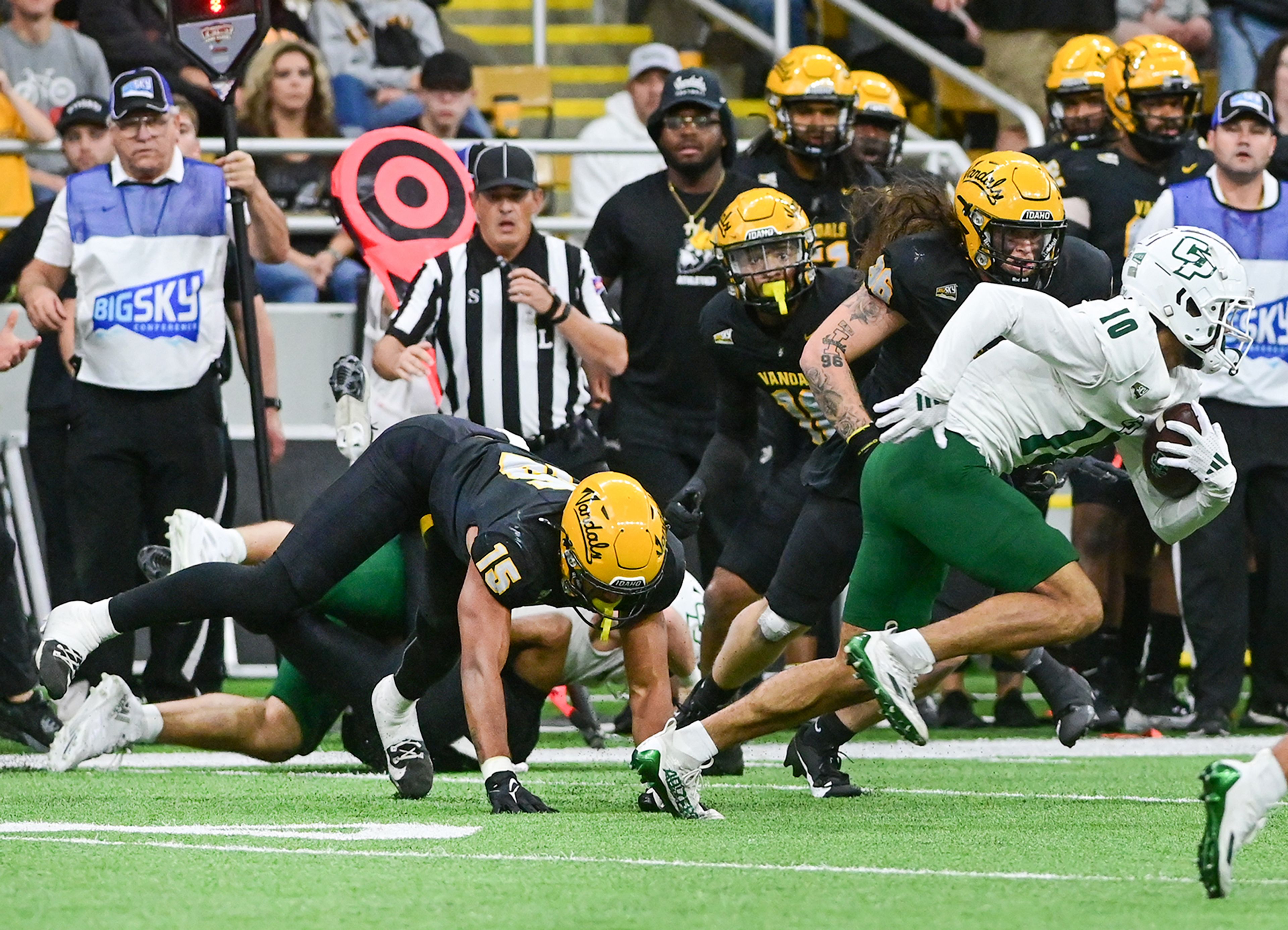 Cal Poly wide receiver Michael Briscoe dodges attempts by Idaho defense, including Idaho defensive lineman Malakai Williams, leading to a Cal Poly touchdown Saturday at the P1FCU Kibbie Dome in Moscow.,