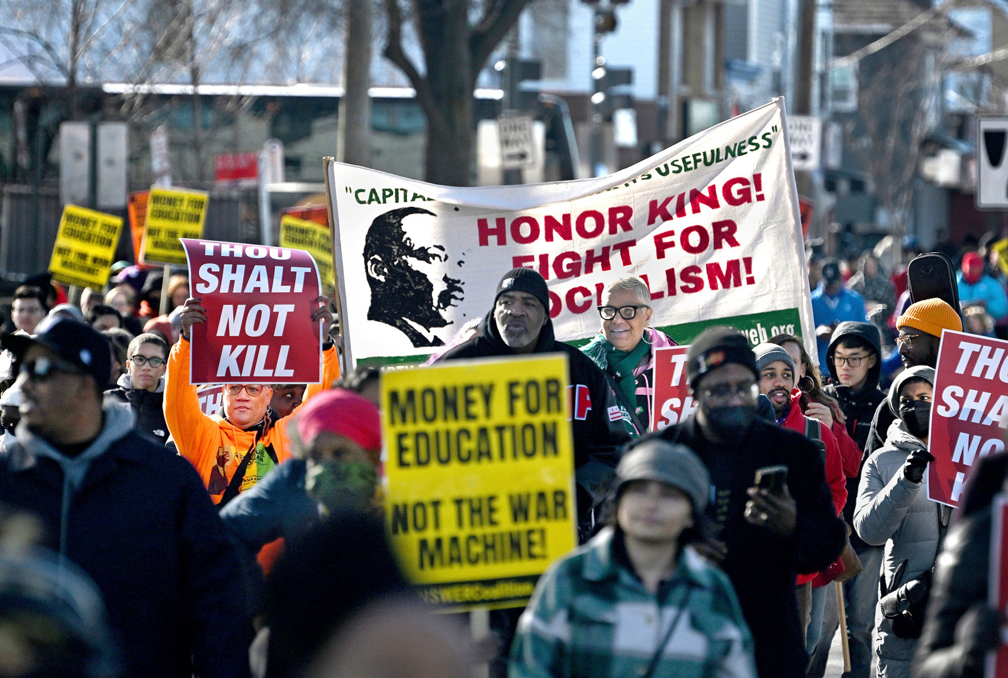 Civic groups, schools and dance troupes along with spectators on the parade route take part in the MLK Holiday Parade held in Washington, D.C. on Monday, Jan. 16, 2023. Peace groups and anti-violence activists were well represented at the event. (Michael S. Williamson/The Washington Post via AP)