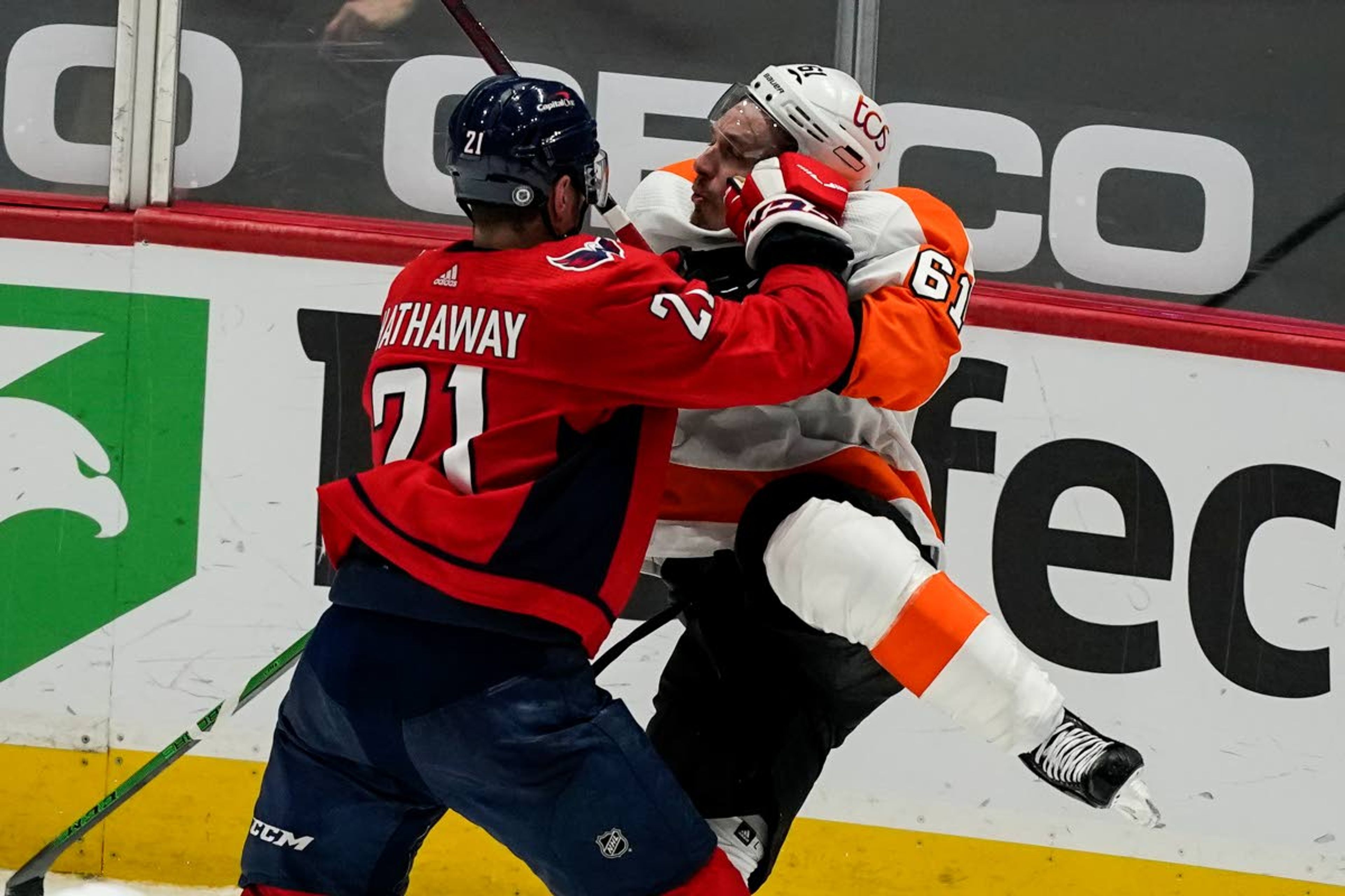 Washington Capitals right wing Garnet Hathaway (21) collides with Philadelphia Flyers defenseman Justin Braun (61) during the second period of an NHL hockey game, Friday, May 7, 2021, in Washington. (AP Photo/Alex Brandon)