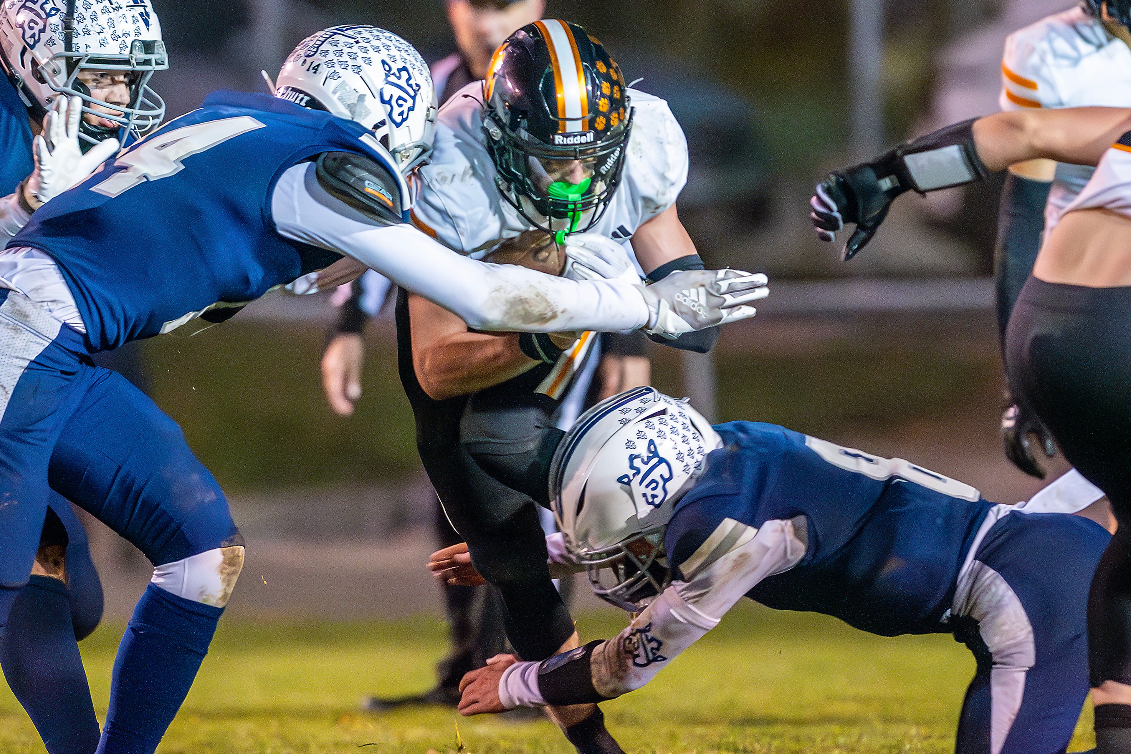 Kendrick running back Sawyer Hewett prepares for a tackle by Logos in a semifinal game of the Idaho State Football Class 2A Championships Friday at Bengal Field in Lewiston.