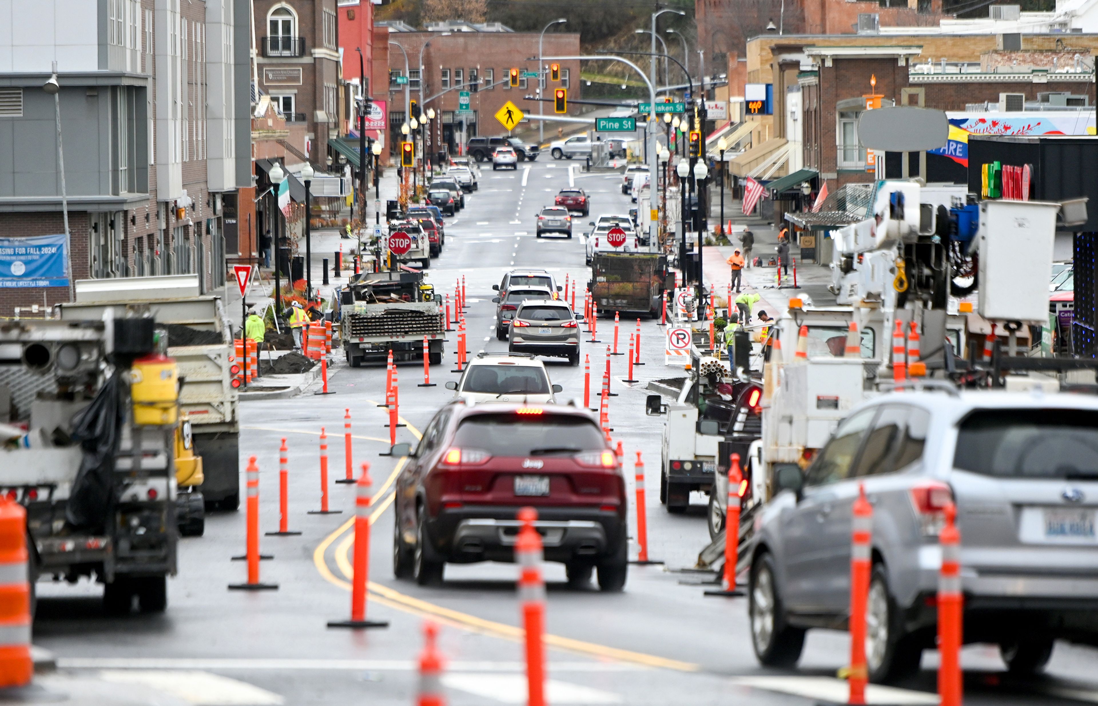 Construction continues along Main Street in downtown Pullman as cars move along a portion of the street Thursday, which was previously estimated as the last day of work on the project.