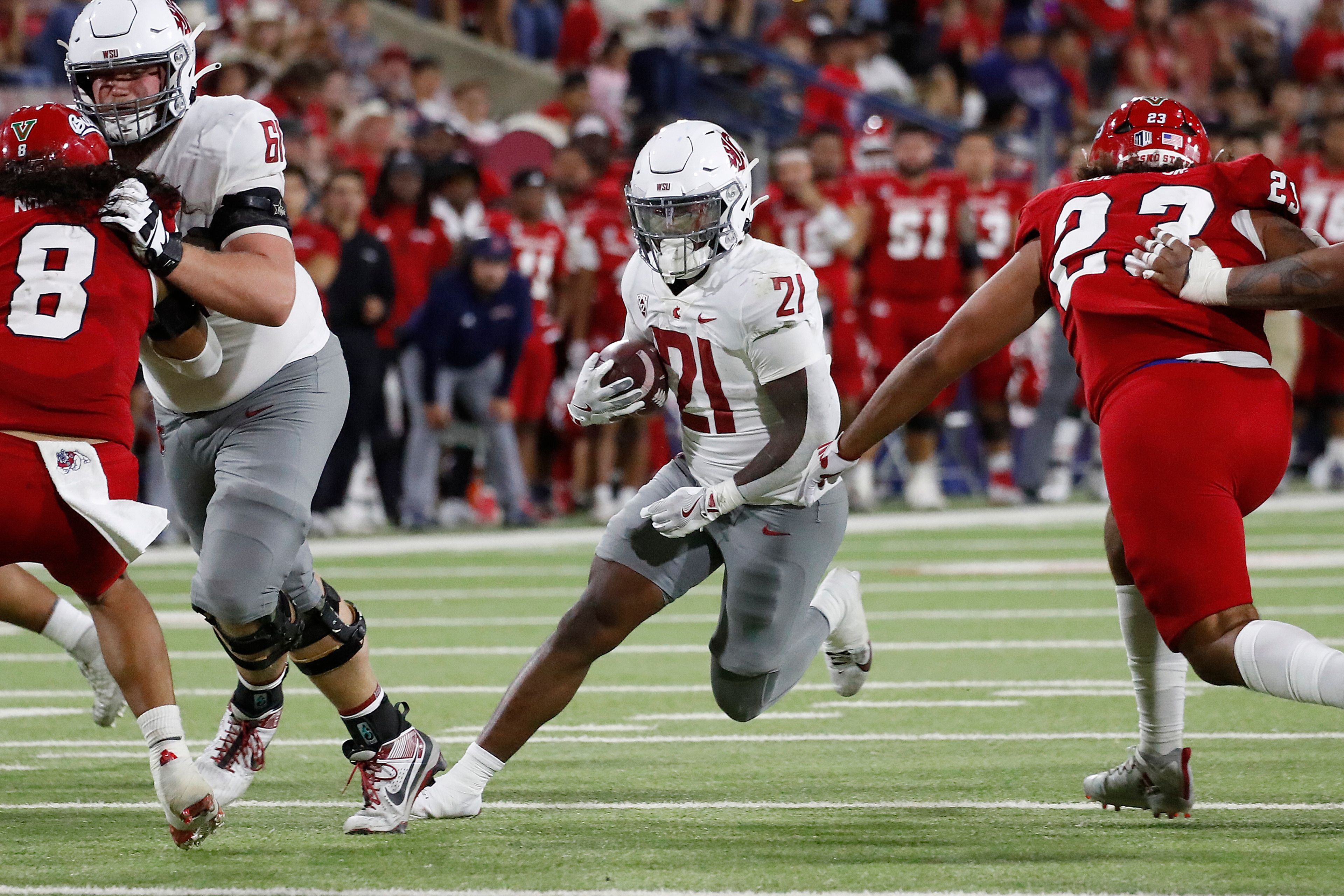 Washington State running back Wayshawn Parker shoots through the line against Fresno State during the second half of an NCAA college football game in Fresno, Calif., Saturday, Oct. 12, 2024. (AP Photo/Gary Kazanjian)