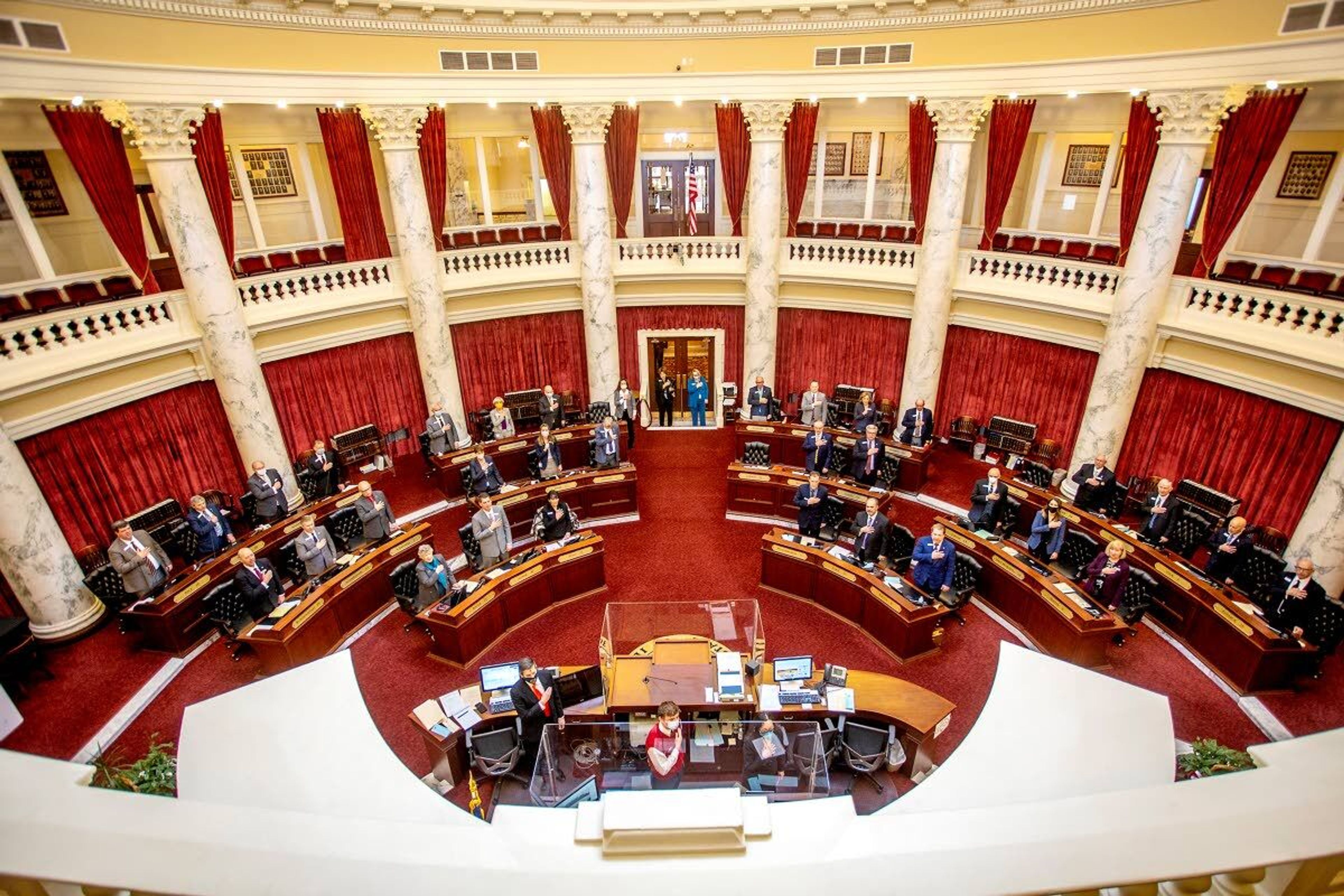 File — Members of the Idaho senate puts hands over hearts for the Pledge of Allegiance.