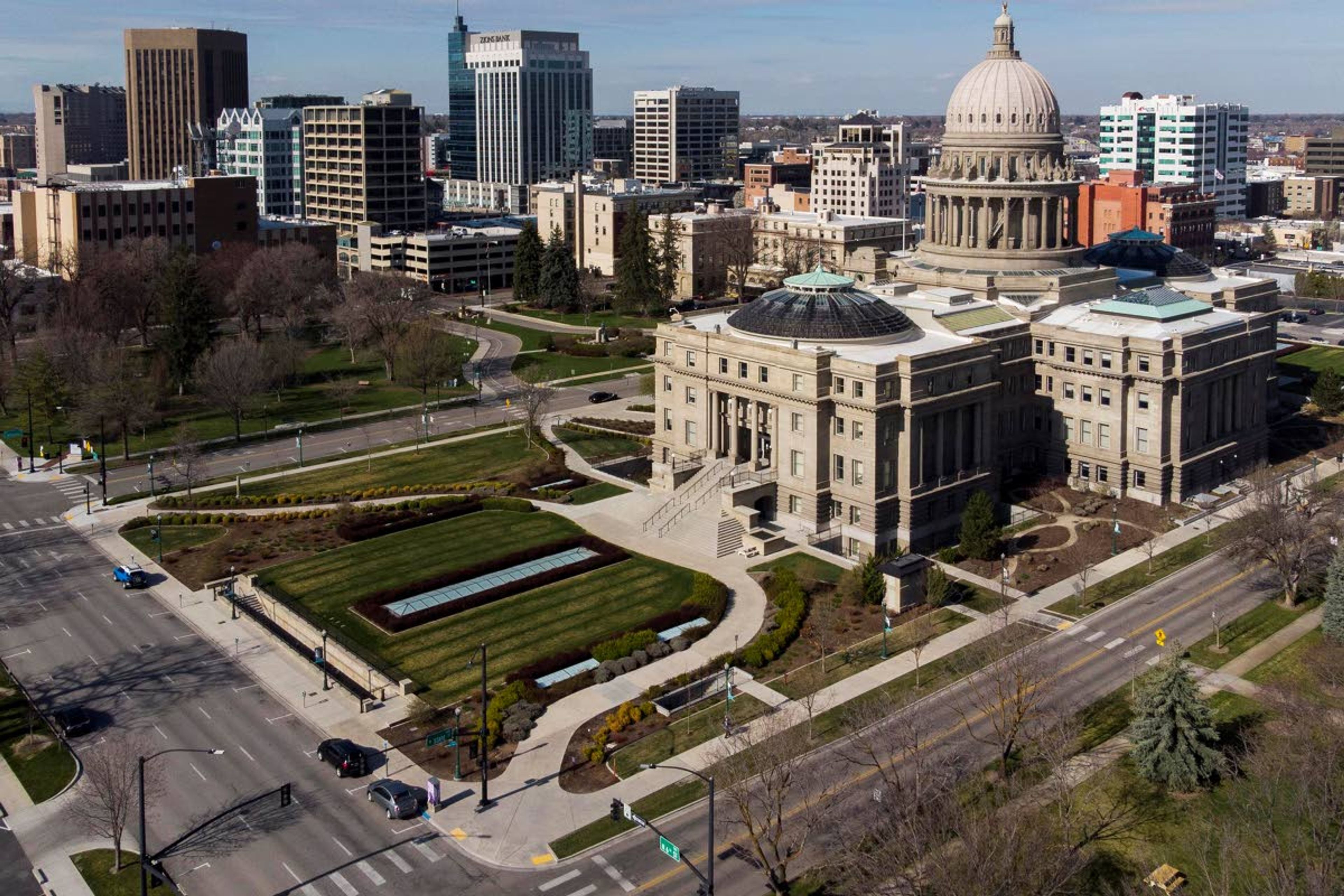 FILE - In this March 27, 2020, file photo, is the Statehouse and skyline in Boise, Idaho. California Attorney General Xavier Becerra on Monday, June 22, 2020, added Idaho to a list of 11 other states where state-funded travel isn't allowed because he determined that they violate a California law. That 2017 law is intended to guard against discrimination based on sexual orientation, gender identity or gender expression. (Darin Oswald/Idaho Statesman via AP, File)