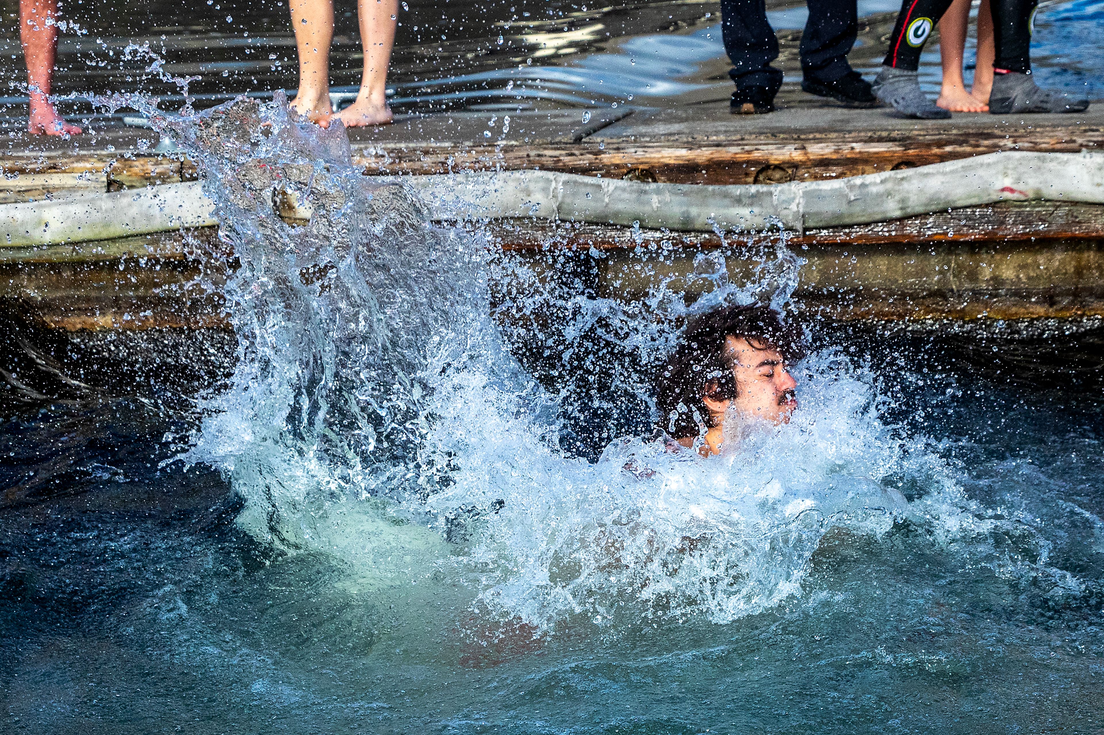 Water splashes up as people take the jump into the Snake River for the annual Polar Plunge Monday in Clarkston.