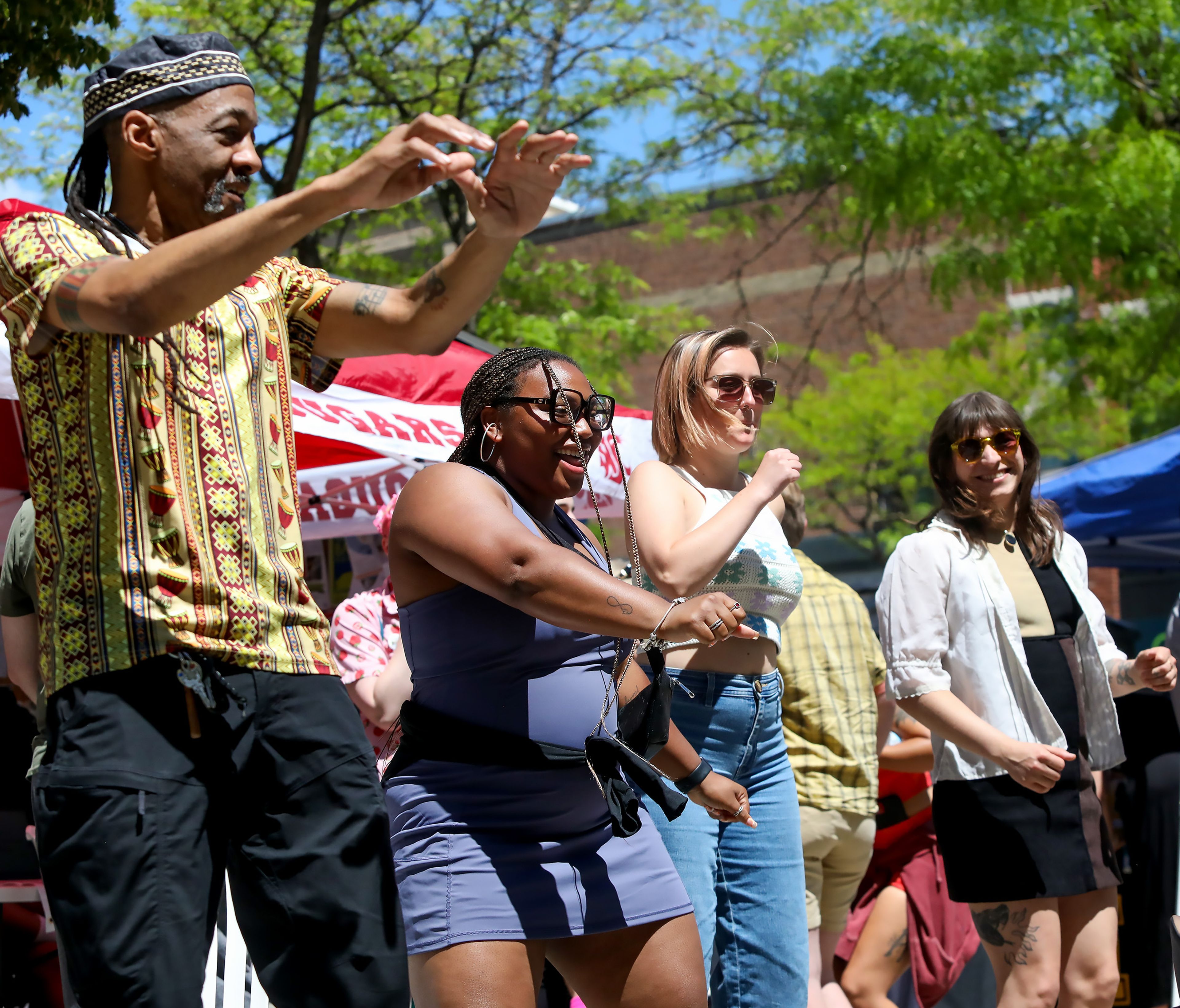 Darryl Singleton, from left, Tori Ector, Taylor Ellsworth and Josie Rodriguez dance to music in Friendship Square during a Juneteenth celebration on Wednesday in Moscow.